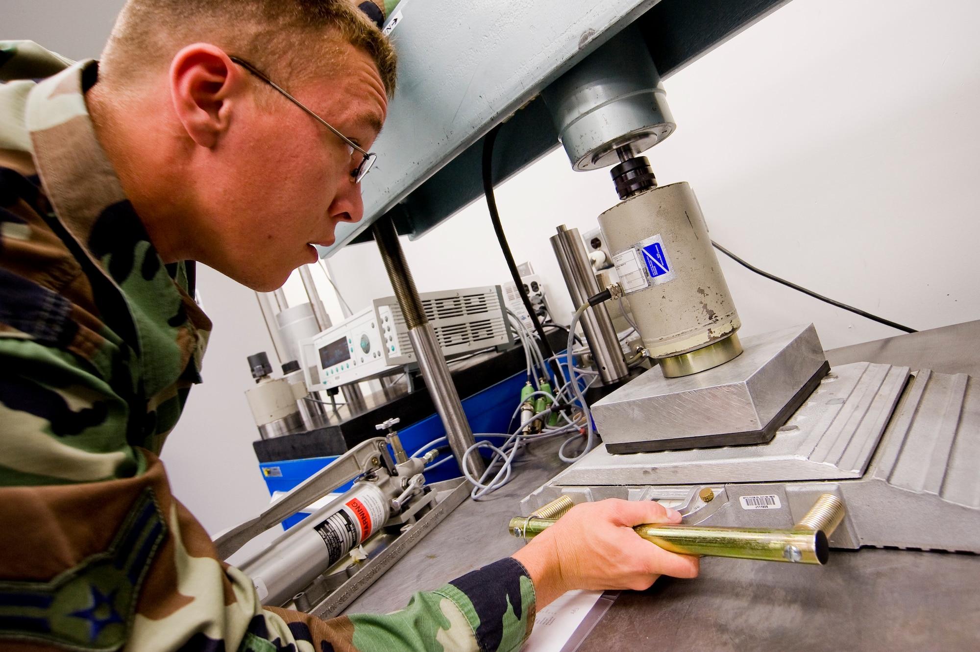 Airman Jared Hahn, 62nd MXS, calibrates a wheel load scale. (U.S. Air Force photo/Abner Guzman)