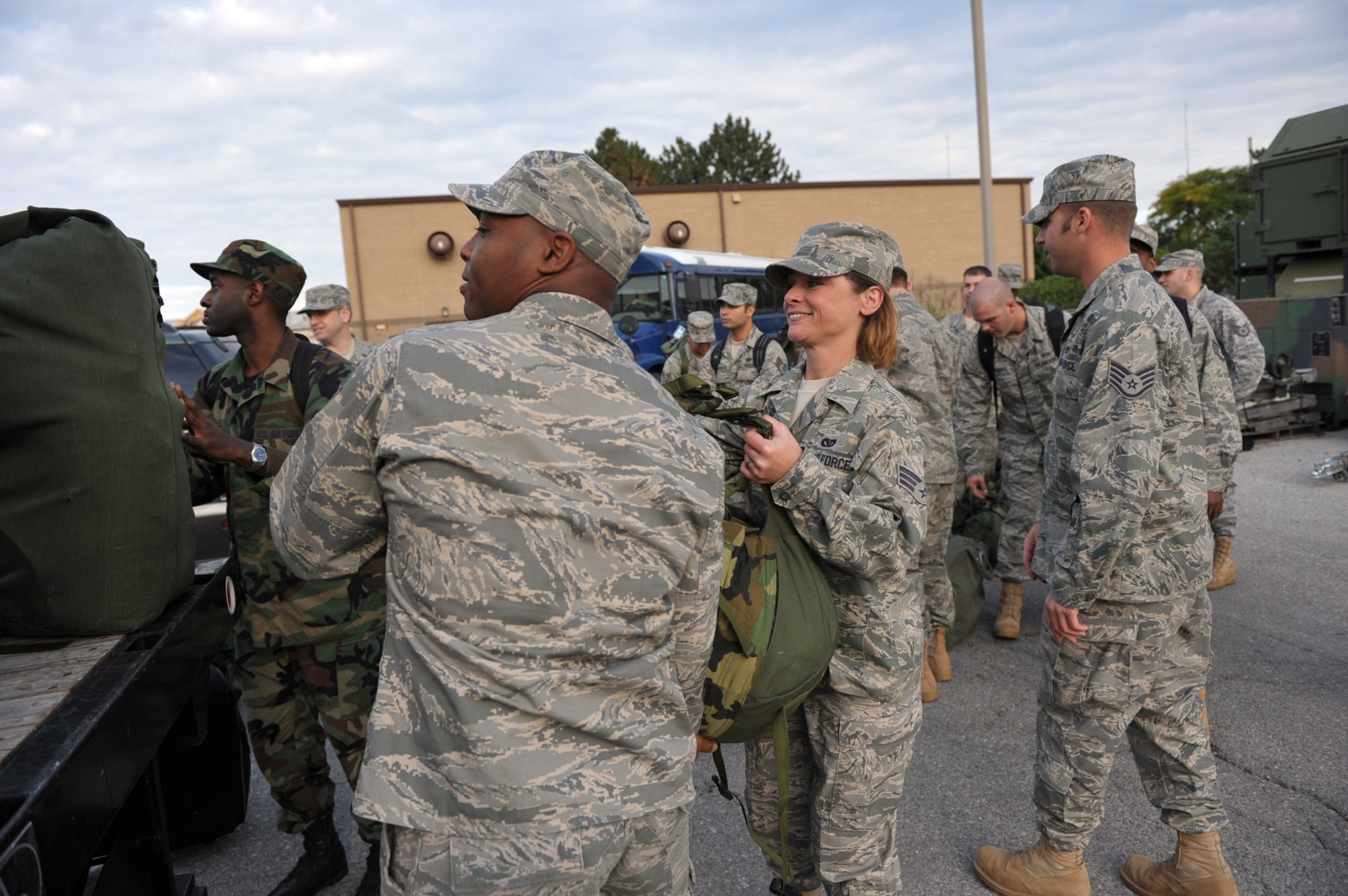 Senior Airman Melody Adair gets some help loading her bag on a truck before she and other Airmen from the 931st Civil Engineer Squadron leave McConnell Air Force Base, Kan., for two weeks of training. Airman Adair is assigned to the squadron's utilities shop. (U.S. Air Force photo/Tech. Sgt. Jason Schaap)