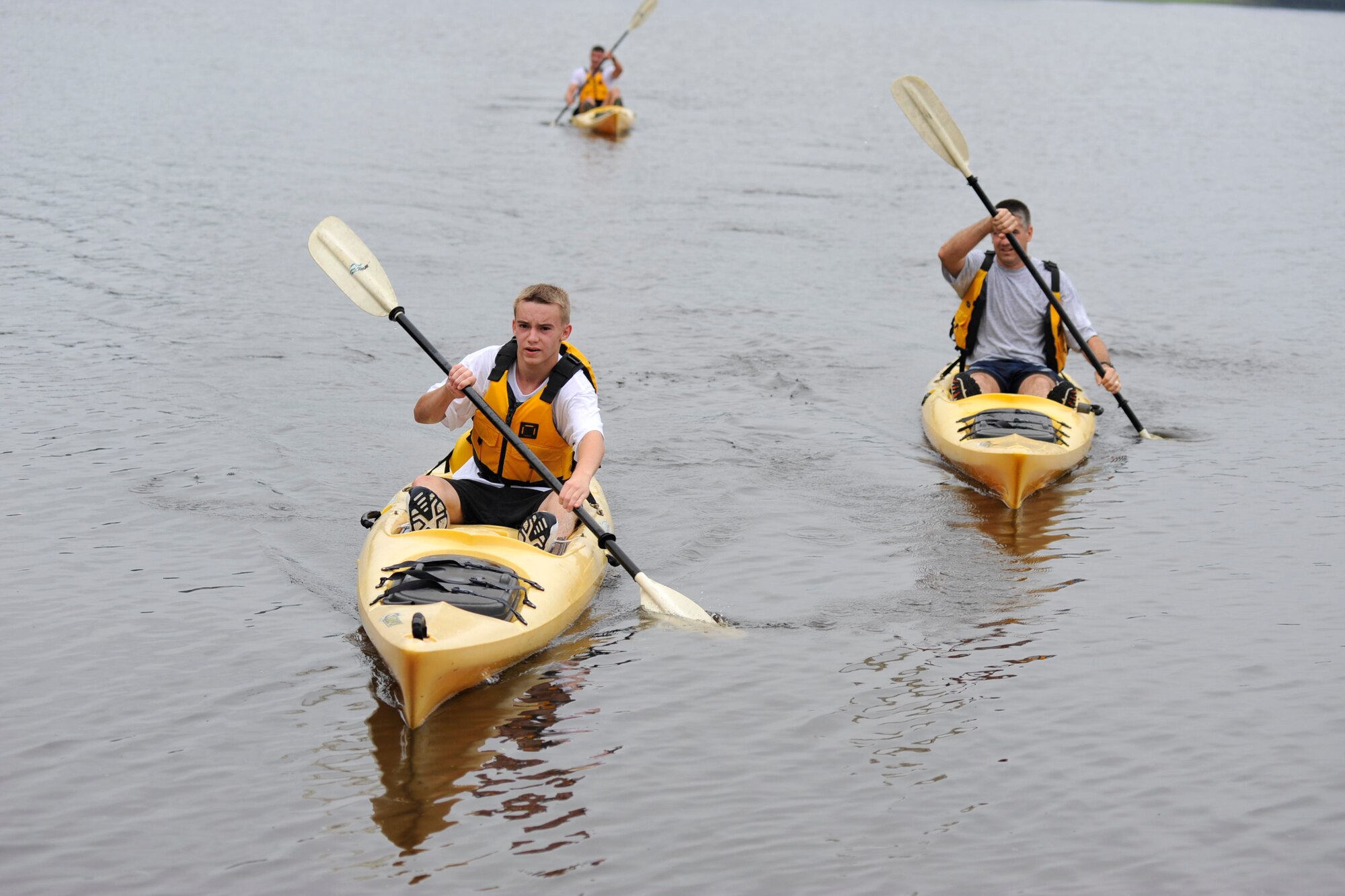 David Starcher (left), son of Master Sgt. Roger Starcher, 19th Equipment Maintenance Squadron, cruise to the finish line during the base Eco Challenge Sept. 19. The Eco Challenge consisted of a 4.7-mile run and a 1.5-mile kayak race. The biking portion of the challenge was cancelled due to poor weather conditions. (U.S. Air Force photo by Airman 1st Class Lausanne Pacheco)
