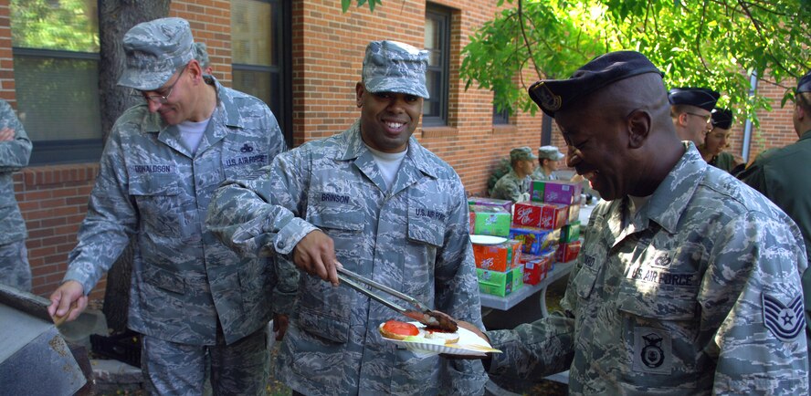 MINOT AIR FORCE BASE, N.D. -- Airmen take part in a base barbeque as part of a team-building exercise called Wingman Day here,  Sept. 18. The 5th Bomb Wing event, which coincided with the Air Force’s 62nd birthday, was held as a means to strengthen the morale and welfare of each unit by empowering and encouraging Airmen to not only become great wingmen, but future leaders. (U.S. Air Force photo by Senior Airman Michael Veloz)