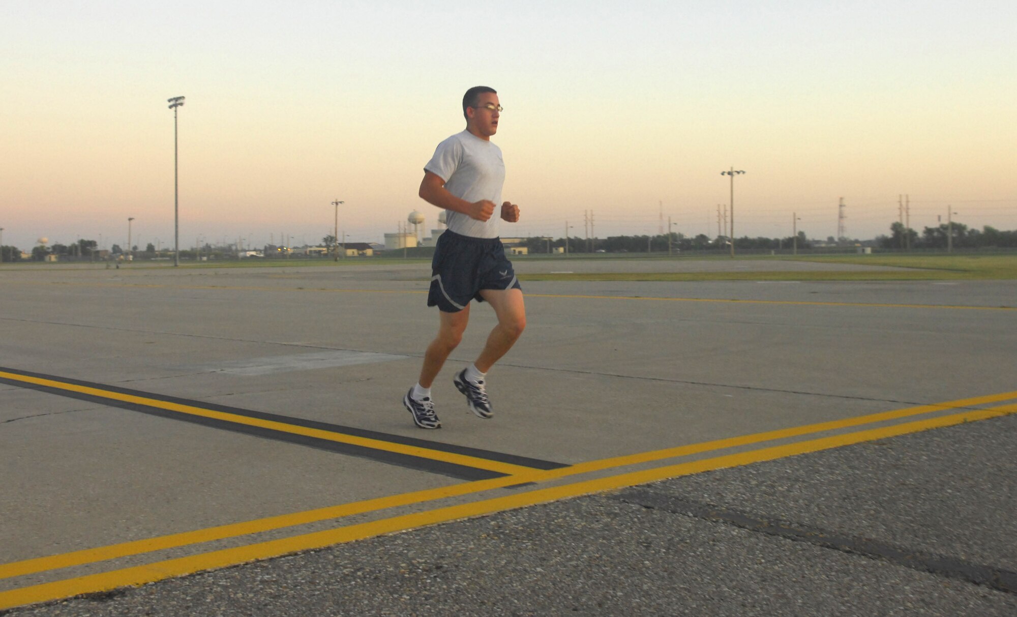 MINOT AIR FORCE BASE, N.D. -- Senior Airman Matthew Beers, 5th Civil Engineer Squadron structural apprentice, crosses the finish line during a flightline run as part of wingman day here Sept. 18. Airman Beers took the top time of the day with a time of 8 minutes and 40 seconds. The 5th Bomb Wing event, which coincided with the Air Force’s 62nd birthday, was held as a means to strengthen the morale and welfare of each unit by empowering and encouraging Airmen to not only become great wingmen, but future leaders. (U.S. Air Force photo by Senior Airman Wesley Wright)