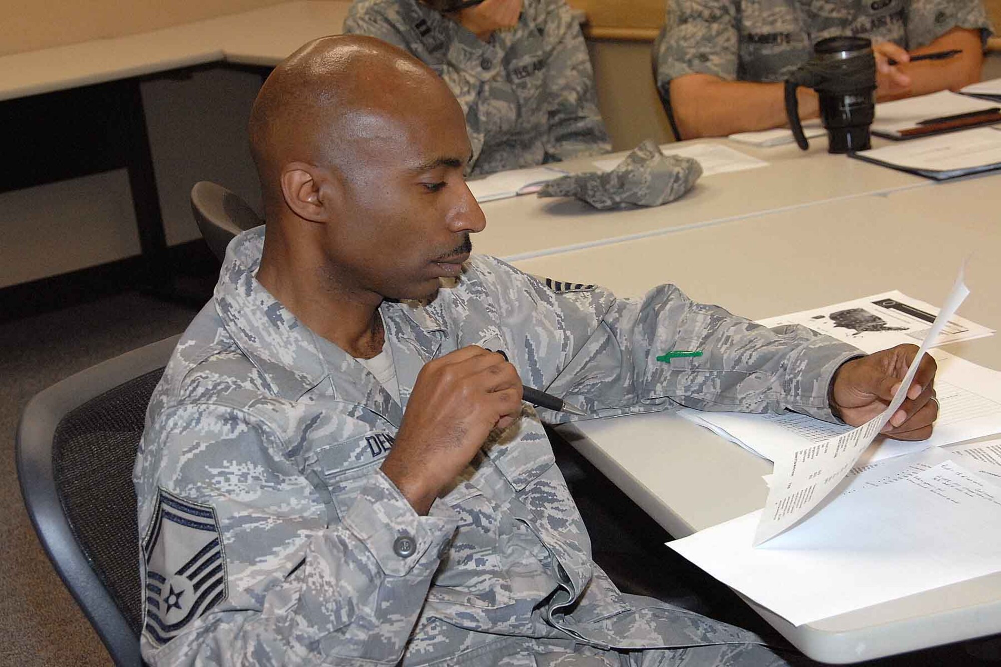 OFFUTT AIR FORCE BASE, Neb. --- Senior Master Sgt. Mervin Dennis, 97th Intelligence Squadron maintenance superintendent, looks at a sample loan during a home-buying workshop presented by the Airman and Family Readiness Center here Aug. 27. A sample loan and a good faith estimate were used as visual aids during the presentation. The workshop covers numerous aspects of buying a home including financing, closing costs and government programs. U.S. Air Force Photo by Kendra Williams