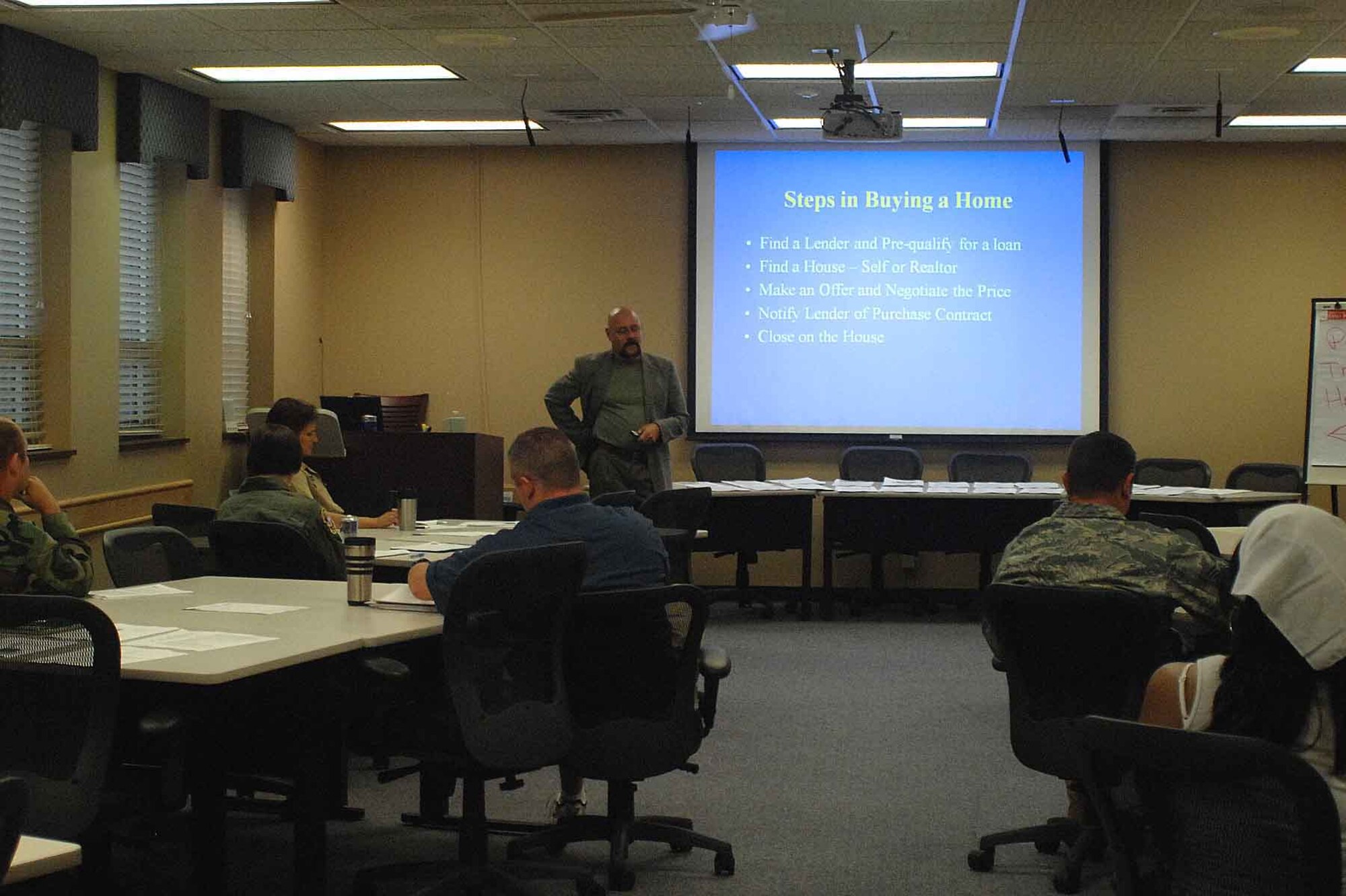 OFFUTT AIR FORCE BASE, Neb. --- Barry Wilkinson, lead work and life consultant with the 55th Force Support Squadron, presents a home-buying workshop to members of Team Offutt at the Airman and Family Readiness Center here Aug. 27. The workshop covered numerous aspects of buying a home including financing, closing costs and government programs. U.S. Air Force Photo by Kendra Williams