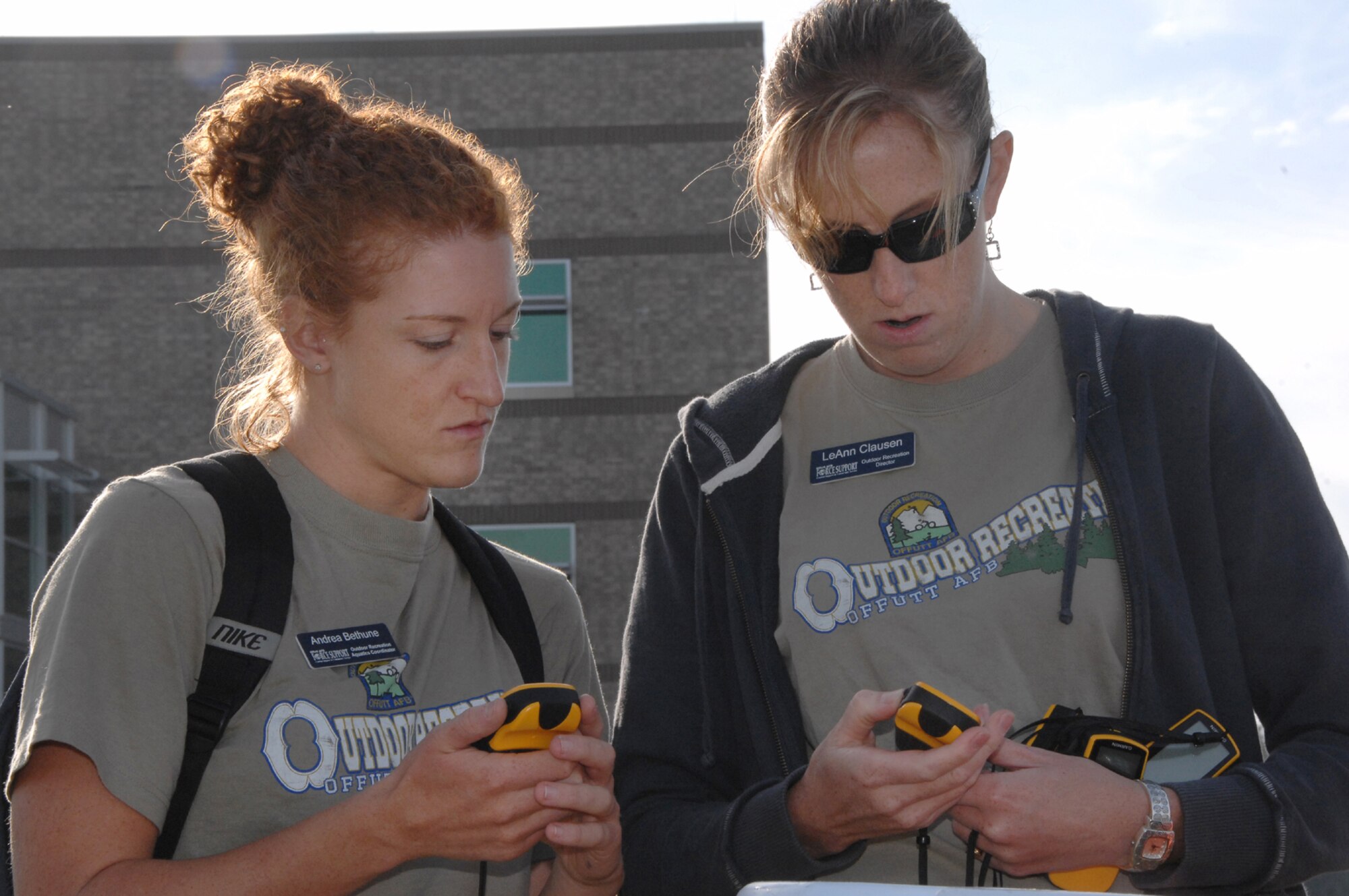 OFFUTT AIR FORCE BASE, Neb. -- Andrea Bethune, (left) an aquatics coordinator for the 55th Force Support Squadron and LeAnn Clausen, (right) director of outdoor recreation for the 55th FSS, ensure each global positioning system works properly prior to the Volksport Walk/Run outside the Air Force Weather Agency here Sept. 19. The event was held on Offutt and in parts of Bellevue, Neb. U.S. Air Force Photo by D.P. Heard