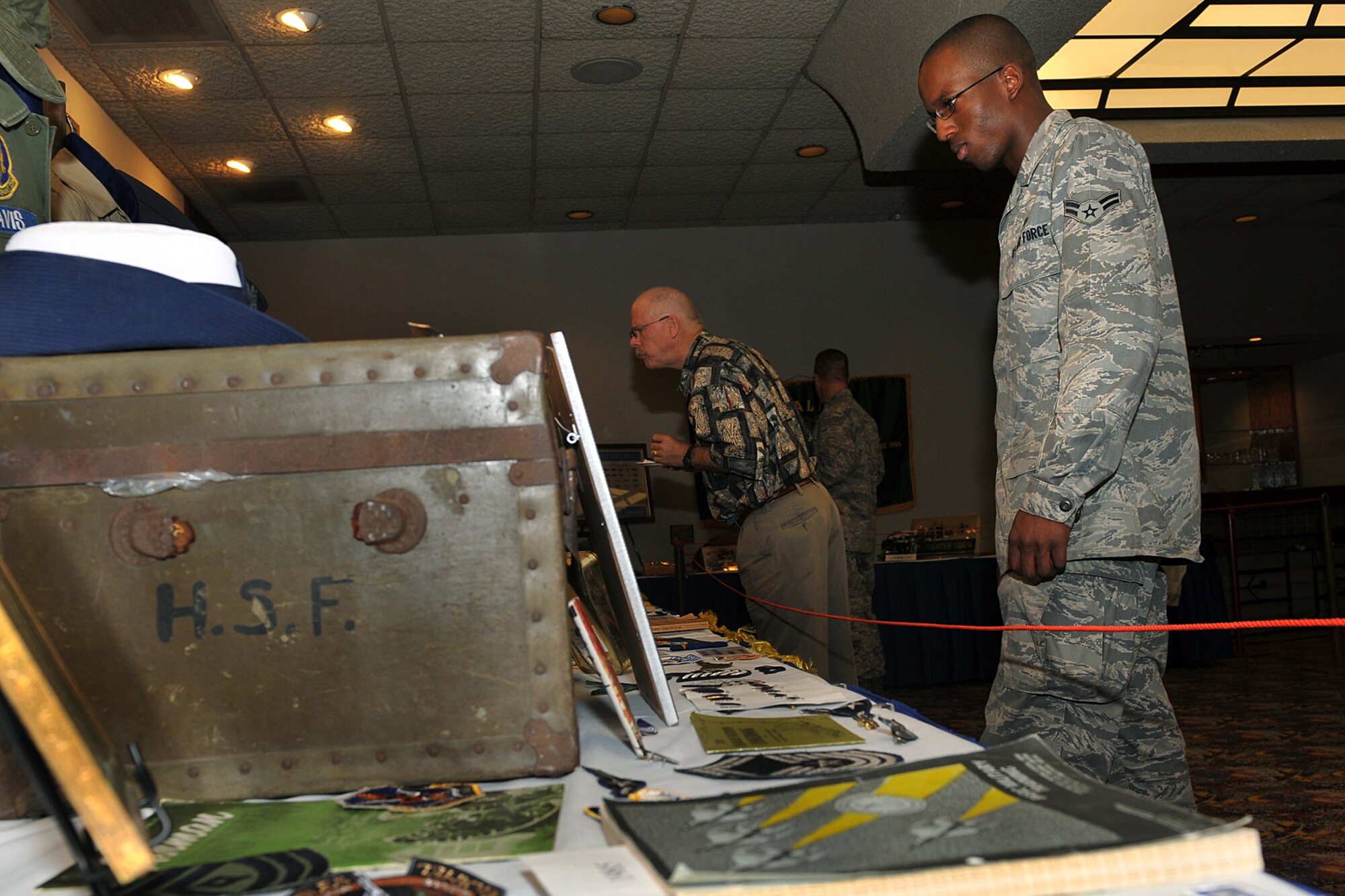 OFFUTT AIR FORCE BASE, Neb. -- Members of Team Offutt look at a mini-enlisted heritage museum during Offutt's 62nd Air Force Birthday Observance at the Patriot Club here Sept. 18. The display consisted of uniforms and other memorabilia dating back to the Spanish American War. Initially a part of the U.S. Army, the Air Force became a separate branch of the military on Sept. 18, 1947. U.S. Air Force Photo by Charles Haymond