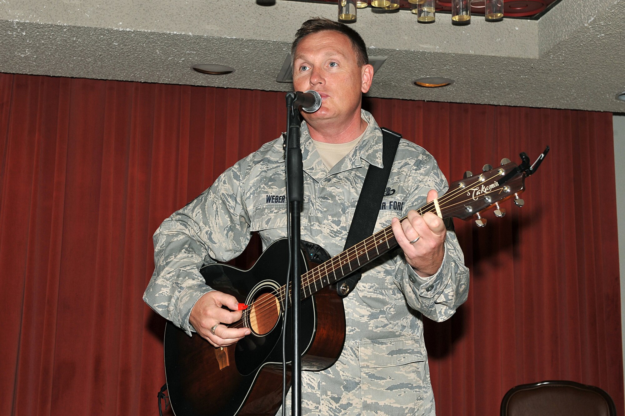 OFFUTT AIR FORCE BASE, Neb., -- Senior Master Sgt. James D. Weber, a guitarist from The Heartland of America Band, performs for members of Team Offutt during Offutt's 62nd Air Force Birthday Observance at the Patriot Club here Sept 18. Sergeant Weber performed numerous songs during the event including "Bye Bye Miss American Pie," "God Bless the USA" and the Air Force song. Initially part of the U. S. Army, the Air Force became a separate branch of the military on September 18, 1947. U.S. Air Force Photo by Charles Haymond