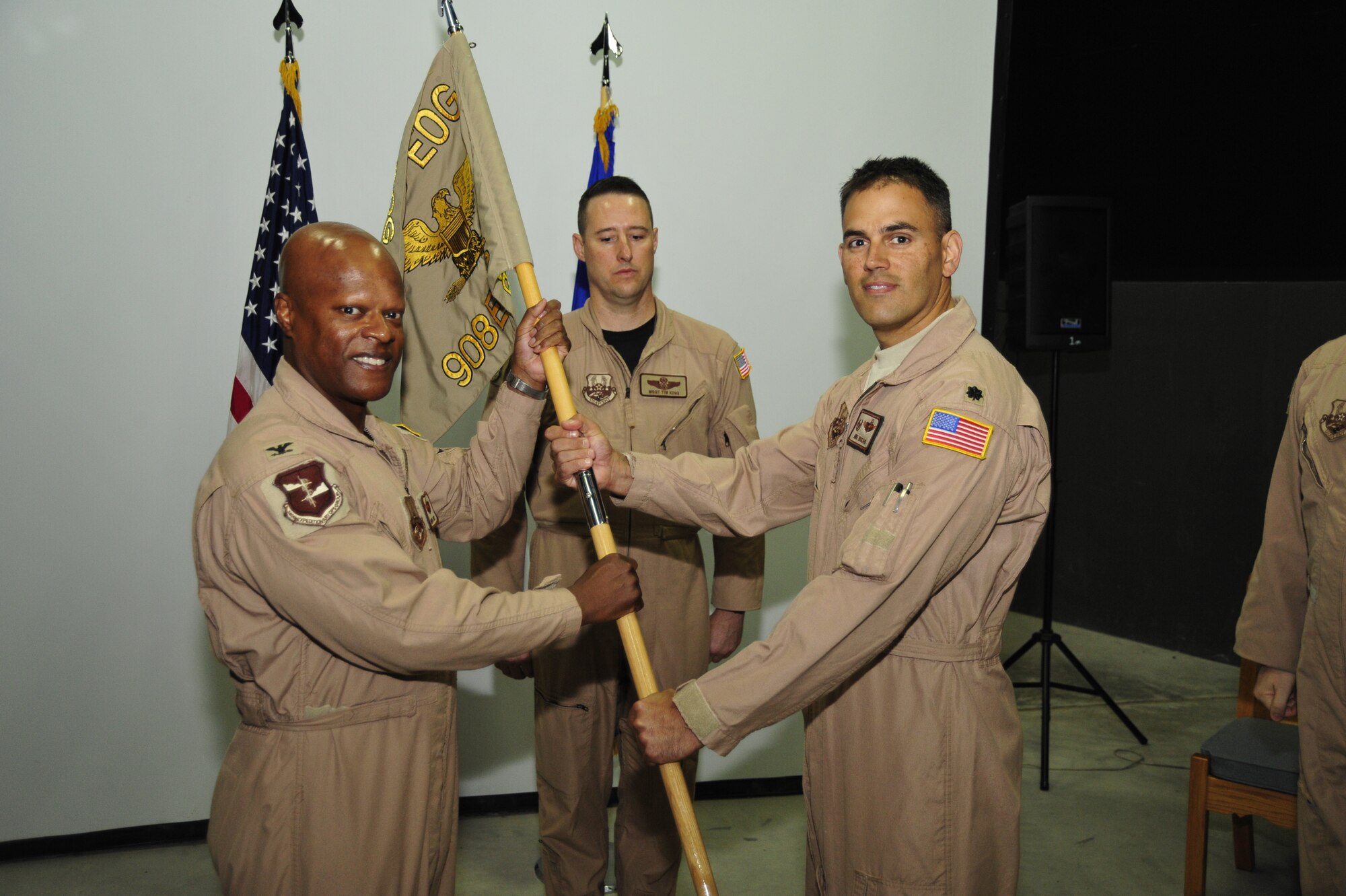 SOUTHWEST ASIA - Lt. Col.  Michael Rickard, 908th Expeditionary Air Refueling Squadron commander, accepts the guidon from Col. Soren Jones, 380th Expeditionary Operations Group commander, during the change of command ceremony Sept 21, 2009.  (U.S. Air Force photo/Tech. Sgt. Charles Larkin Sr)