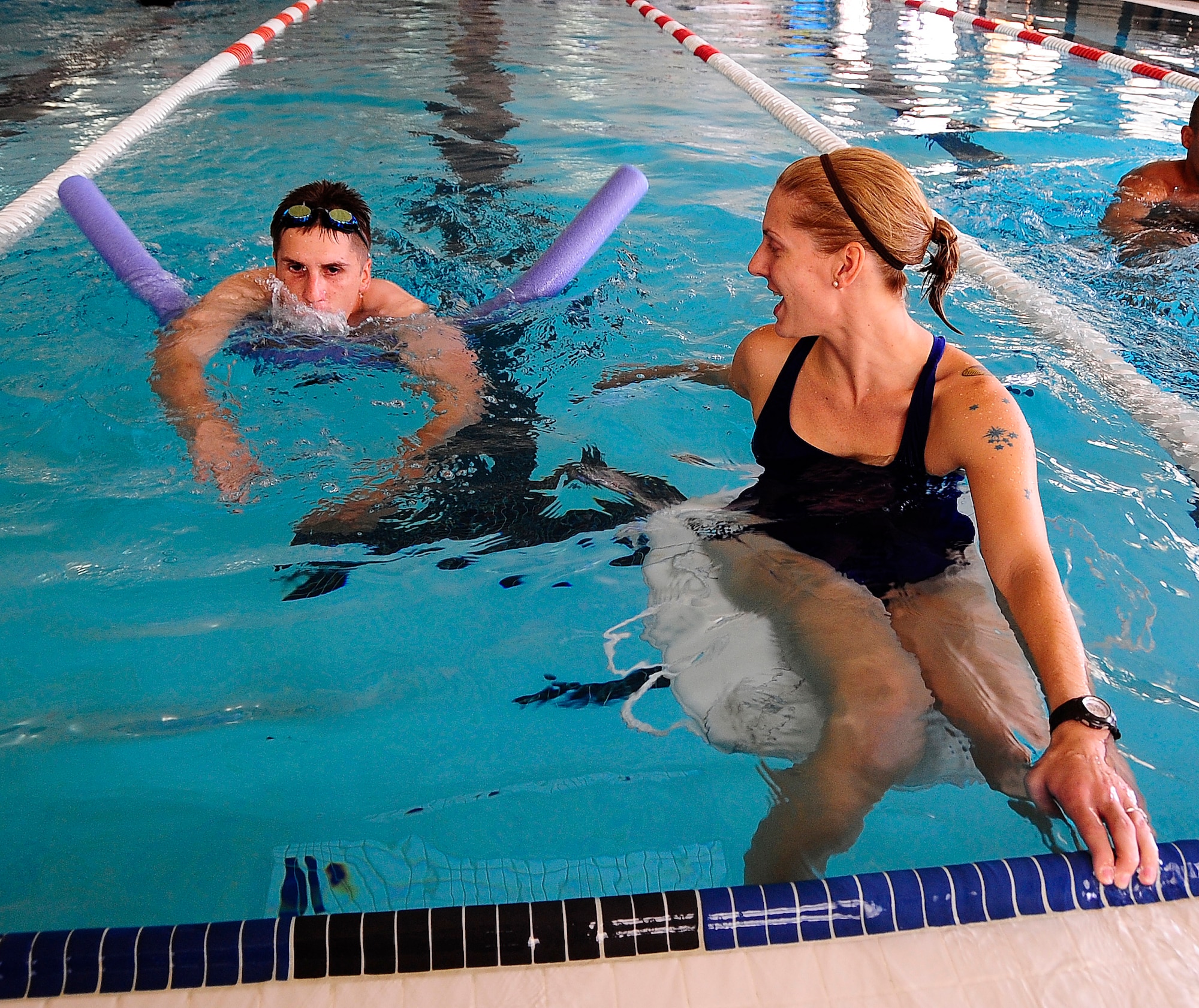 HOLLOMAN AIR FORCE BASE, N.M. -- Airman 1st Class David Klimas and Tech. Sgt. Amanda Wright of the 49th Force Support Squadron participate in a swimming relay race during the Wing Sports Day, Sept. 18. (U.S.Air Force photo by Tech. Sgt. Chris Flahive)