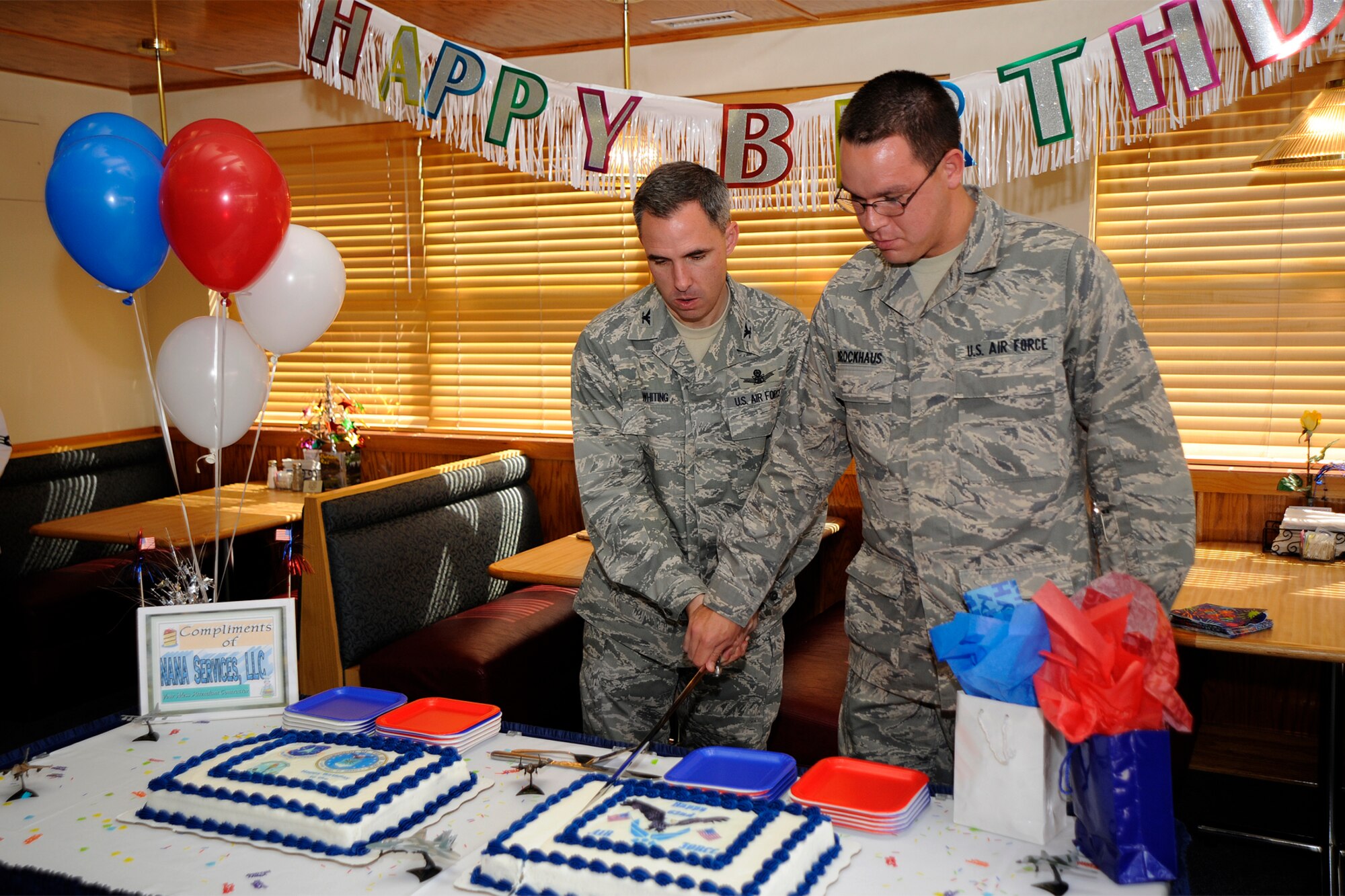PETERSON AIR FORCE BASE, Colo. – Col. Stephen Whiting, 21st Space Wing commander and Airman Kurt Brockhaus, 561st Network Operations Squadron, cut the Air Force birthday cake during the U.S. Air Force’s 62nd birthday celebration Sept. 18 at the Aragon Dining Facility. The event featured a lunch, the cake cutting ceremony, and a short presentation on the history of Peterson from Jeff Nash, Peterson Air and Space Museum deputy director and curator. This celebration also served as the monthly birthday celebration meal for Team Pete Airmen. (Air Force photo by Craig Denton)