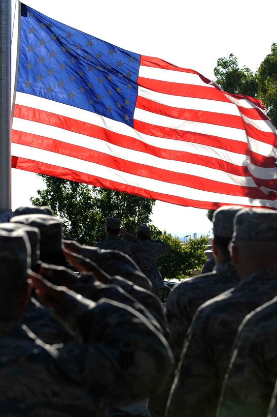 ELLSWORTH AIR FORCE BASE, S.D. -- Airmen salute the American flag as it is lowered during the Prisoners of War/Missing in Action Remembrance Day retreat ceremony, Sept. 18. The entire day was dedicated to remembering servicemembers taken as prisoners of war or missing in action. (U.S. Air Force photo Airman 1st Class Corey/Hook)