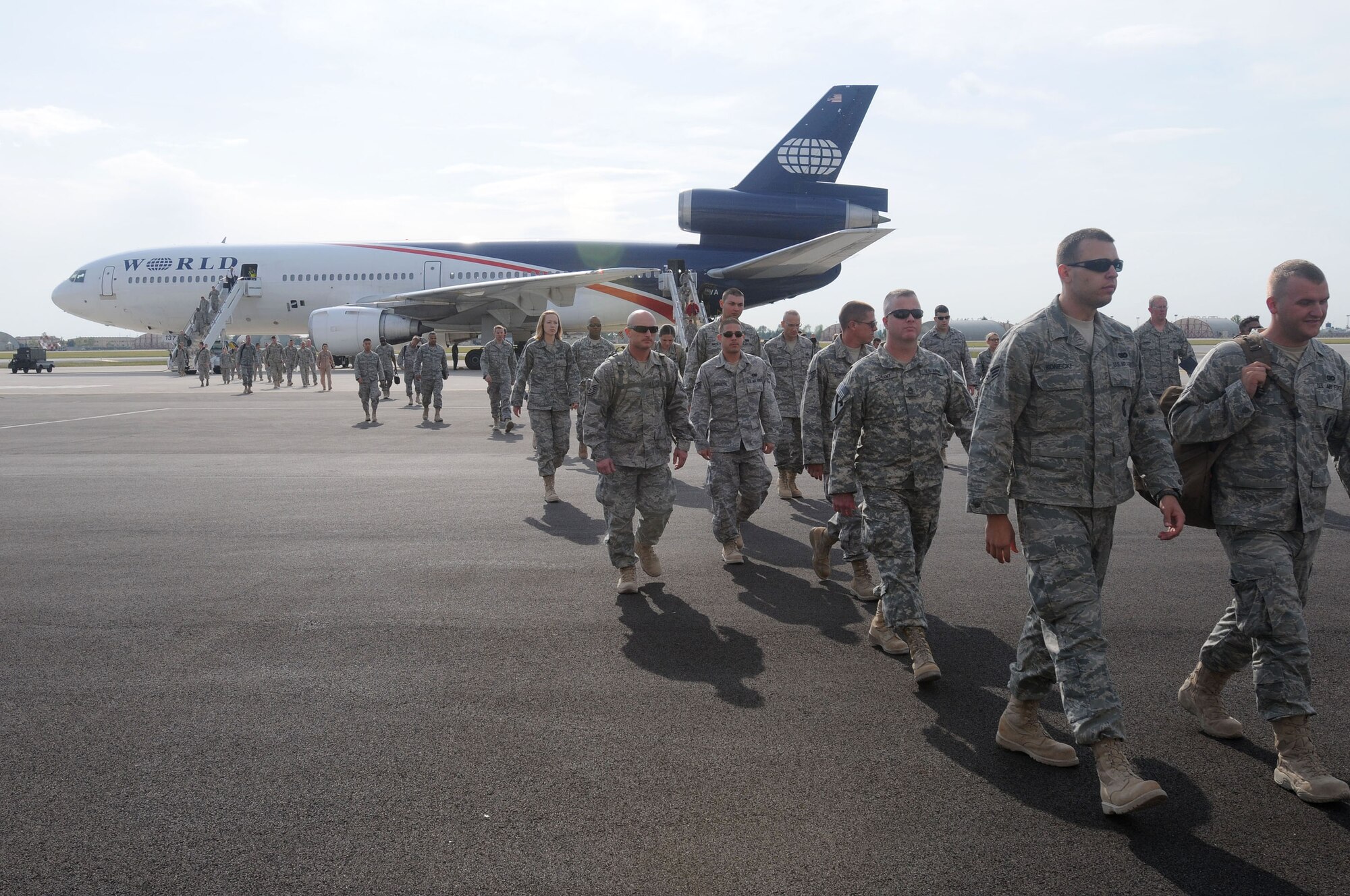 Military servicemembers returning from deployment disembark a government chartered aircraft arriving from an air base in Southwest Asia, Sept. 11, 2009 at Aviano Air Base, Italy.  The servicemembers were amongst the first to utilize the new passenger and air freight terminal at Aviano AB since it opened for passenger processing Sept. 10.  (U.S. Air Force photo/Airman 1st Class Ashley Wood)