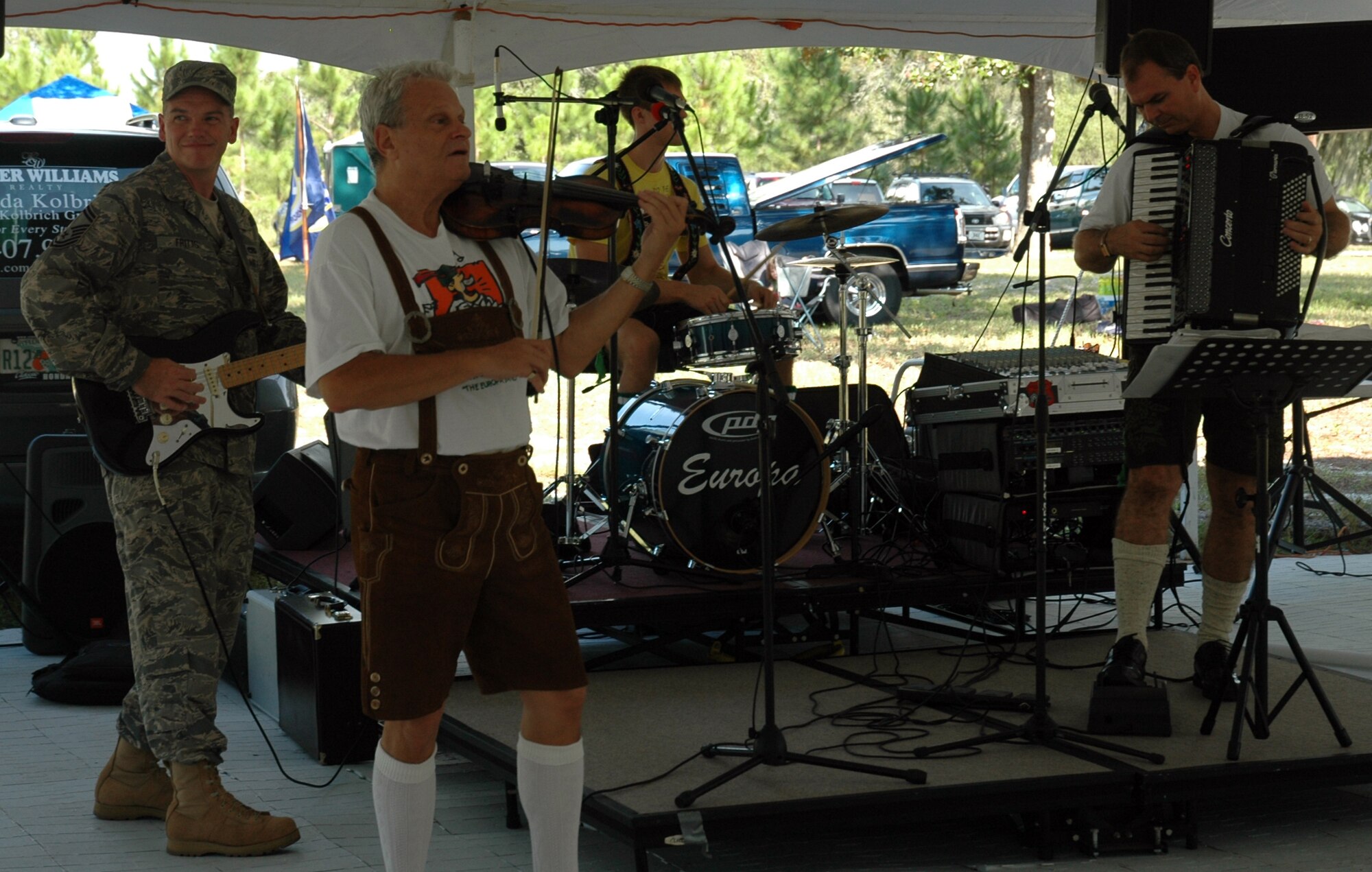 Senior Master Sgt. Fritts, 325th Force Support Squadron Career Assistant Advisor, helps Europa warm up before beginning his duties as Master of Ceremonies. (U.S. Air Force photo by Airman 1st Class Rachelle Elsea)
