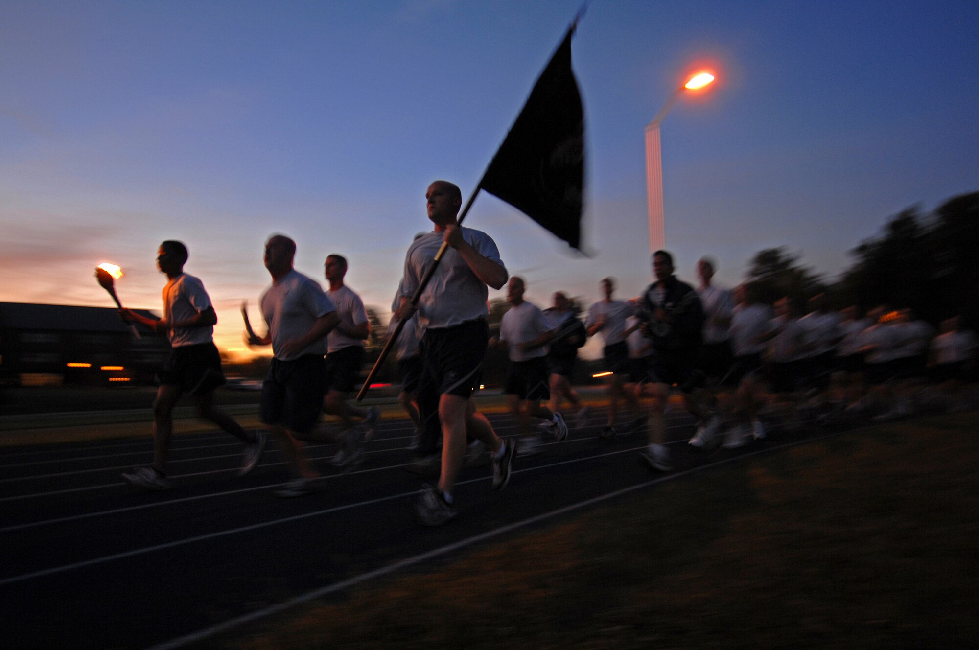 WHITEMAN AIR FORCE BASE, Mo. - Members of the 509th Security Forces Squadron start off the first leg of the POW/MIA run Sept. 18 at 6 a.m. The POW/MIA run is a 24-hour torch and flag run to honor prisoners of war and missing-in-action personnel. Staff Sgts Amir Hasan and Brandon Lines, 509th Munitions Squadron, organized the 24-hour run and scheduled it to kick off at 6 a.m. the morning of the Air Force's 62nd anniversary. Several military and civilian personnel from 24 different organizations participated in the run. (U.S. Air Force photo/ Senior Airman Kenny Holston)