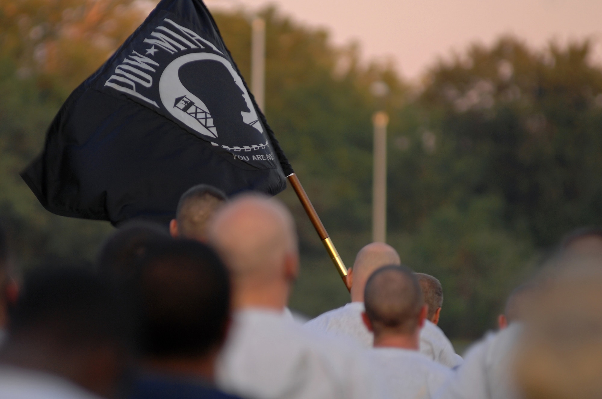 WHITEMAN AIR FORCE BASE, Mo. - The prisoners of war and missing-in-action flag flies as personnel with the 509th Communications Squadron complete their leg of the POW/MIA run, Sept. 18. The POW/MIA run is a 24-hour torch and flag run to honor prisoners of war and missing-in-action personnel. Staff Sgts. Amir Hasan and Brandon Lines, 509th Munitions Squadron, organized the 24-hour run and scheduled it to kick off at 6 a.m. the morning of the Air Forces 62nd anniversary. Several military and civilian personnel from 24 different organizations participated in the run. (U.S. Air Force photo/Senior Airman Kenny Holston)