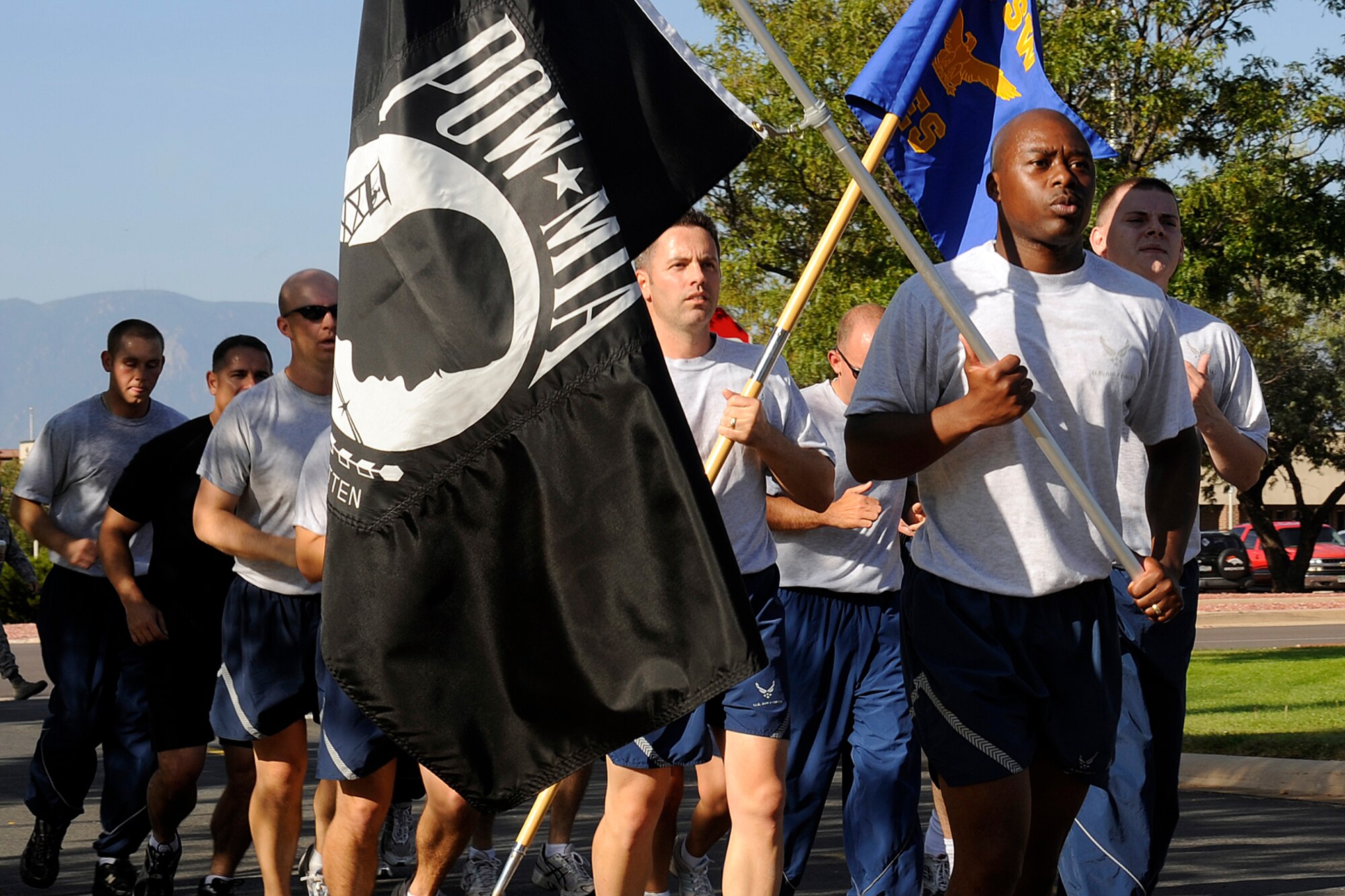 A flight of Airmen, Soldiers and civilians jog the last leg of the 24-hour POW/MIA run Sept. 18 before posting the POW/MIA flag in front of the base chapel. The end of the run signified the beginning of Peterson’s POW/MIA Recognition Day ceremony and marked the conclusion of National POW/MIA week. The 21st Space Wing hosted several events during this week including a Reveille ceremony, the run and a candlelight vigil. Col. (ret) Gordon Scott, a former POW, was the guest speaker Friday at the chapel. (Air Force photo by Larry Hulst)   

