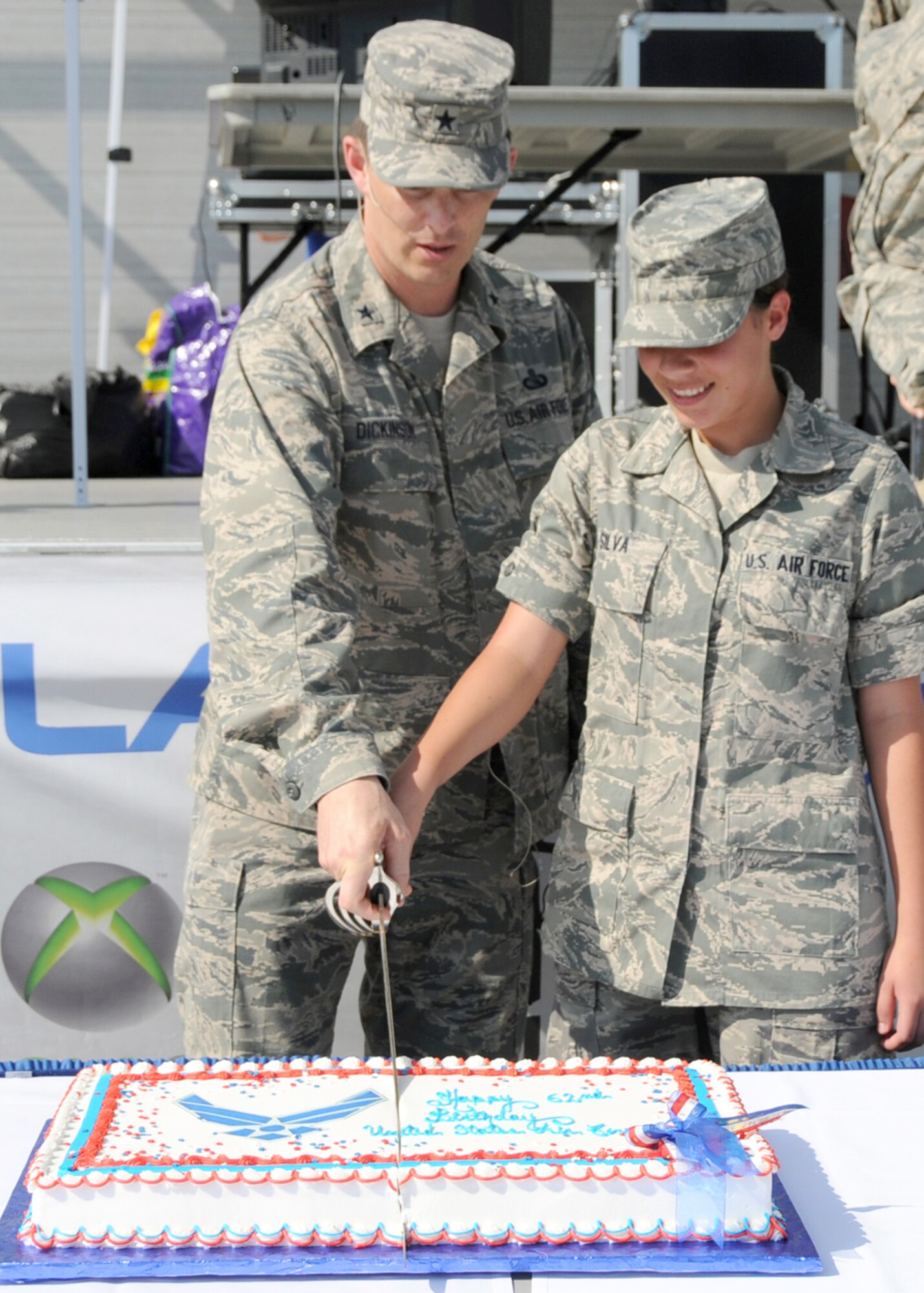 Brig. Gen. Ian Dickinson, 81st Training Wing commander, joins Keesler’s youngest airman, Airman Basic Monique Silva, in cutting the cake during the base’s celebration of the Air Force’s 62nd birthday.  Airman Silva, 17, is a student in the 335th TRS.  (U.S. Air Force photo by Kemberly Groue)