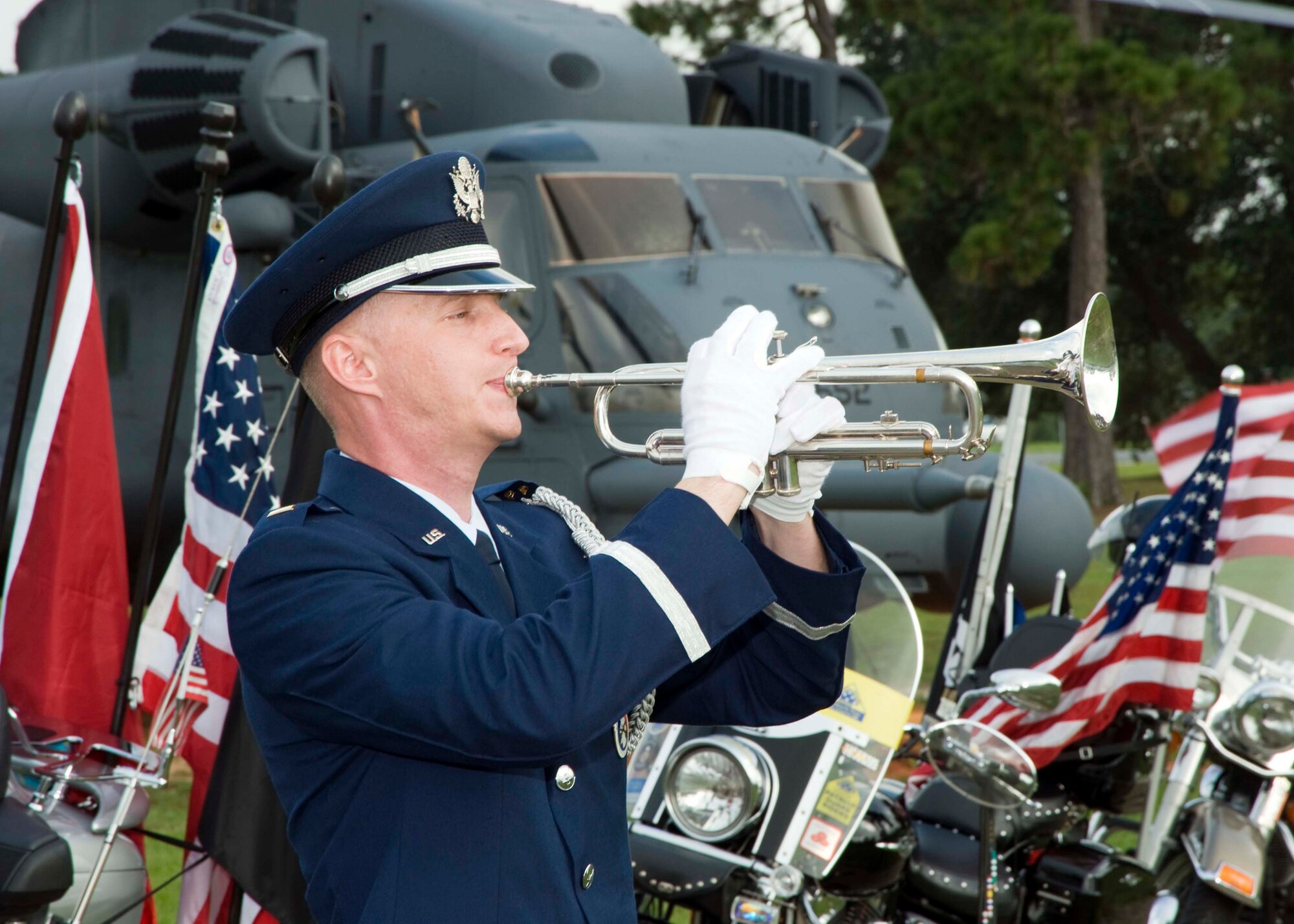 1st Lt. Adam Baker plays Taps on the bugle during the POW/MIA ceremony Sept. 18 at the Air Armament Museum.  The ceremony had guest speakers, honor guard and a fly over by the 85th Test and Evaluation Squadron.  (U.S. Air Force photo/Mike Fleck.)