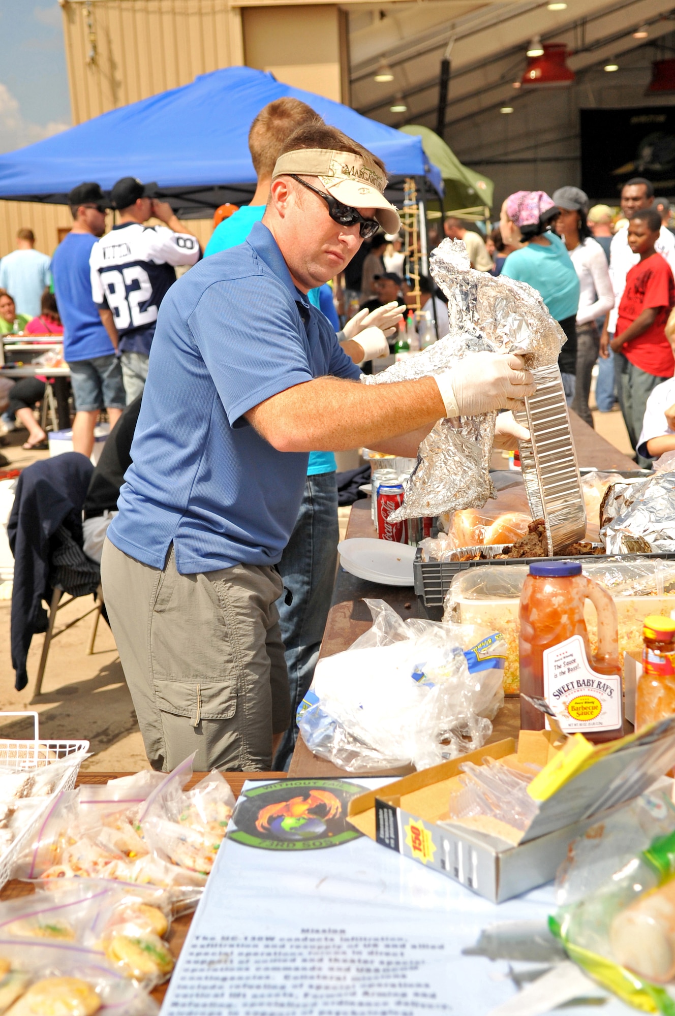 CANNON AFB, N.M.--Major Michael Boyer, 73rd Special Operations Squadron, prepares pulled pork sandwiches for the 73rd SOS booster club during Commando Family Day here Sept. 19.  Booster clubs from around the base set up food booths for squadron events such as Christmas parties and retirement ceremonies.  (U.S. Air Force photo by Staff Sgt. Heather R. Redman/RELEASED)