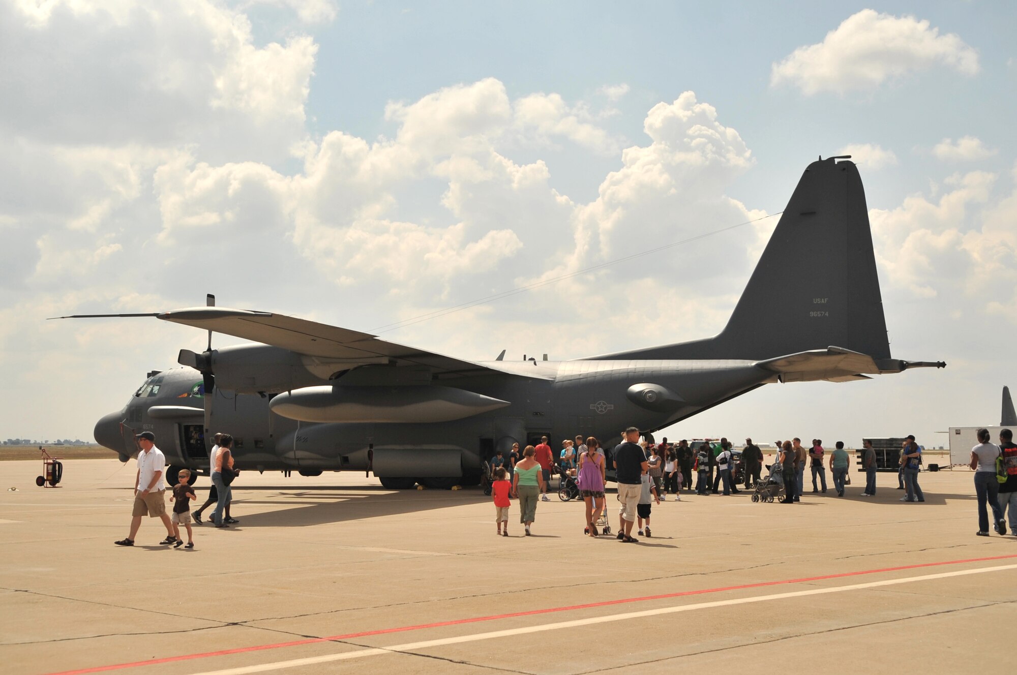 CANNON AFB, N.M.--Airmen and their families line up to take a tour of an AC-130H gunship during Commando Family Day here Sept. 19.  The AC-130H gunship was part of a static display of four aircraft that Airmen and families toured.  (U.S. Air Force photo by Staff Sgt. Heather R. Redman/RELEASED)