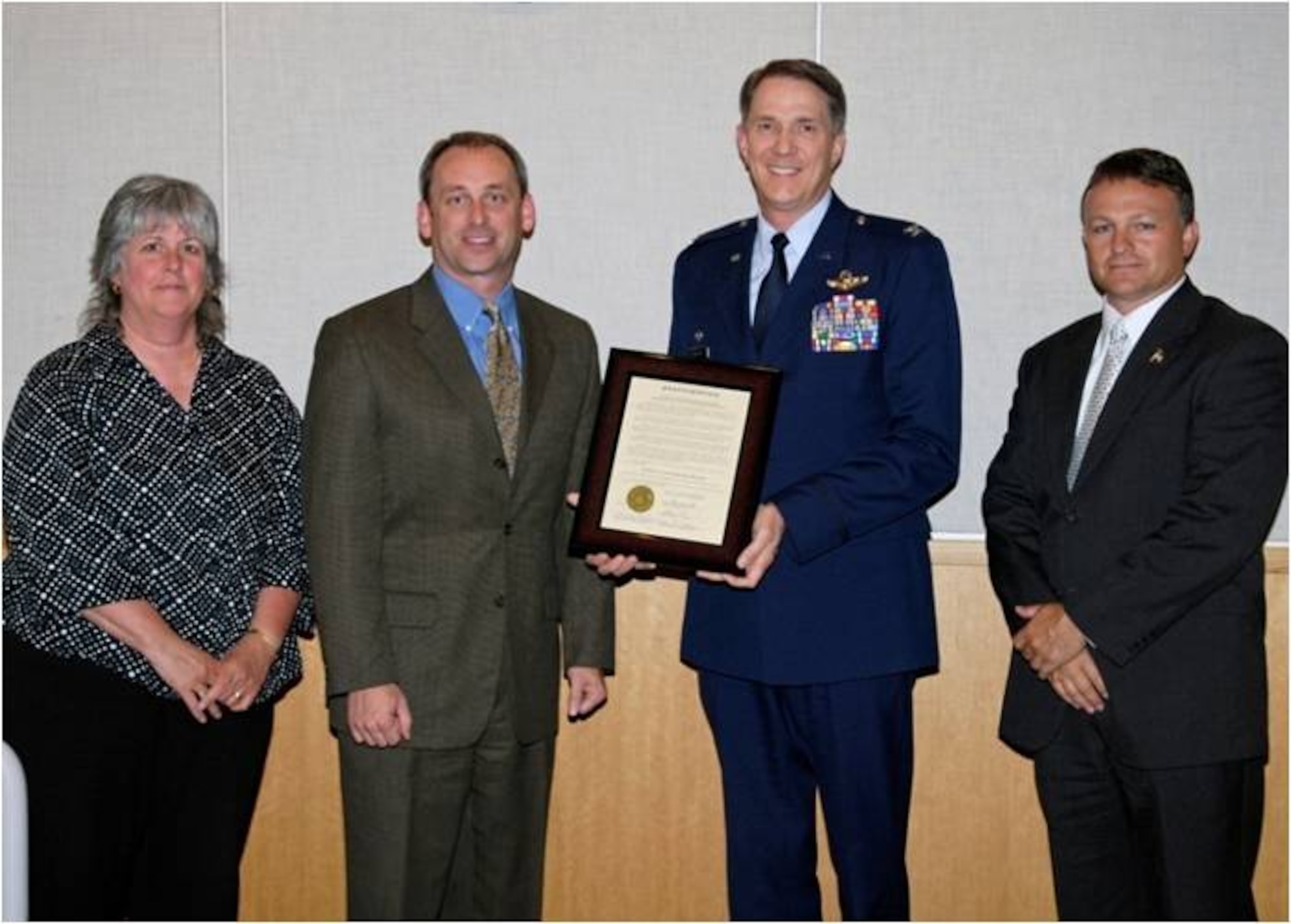 Spokane County District 3 Commissioner Bonnie Mager, District 1 Commissioner Todd Mielke, 141 Air Refueling Wing Commander Col. Greg Bulkley and District 2 Commissioner Mark Richard stand with the proclamation certificate recognizing the month of August 2009 as Washington Air National Guard Appreciation Month.