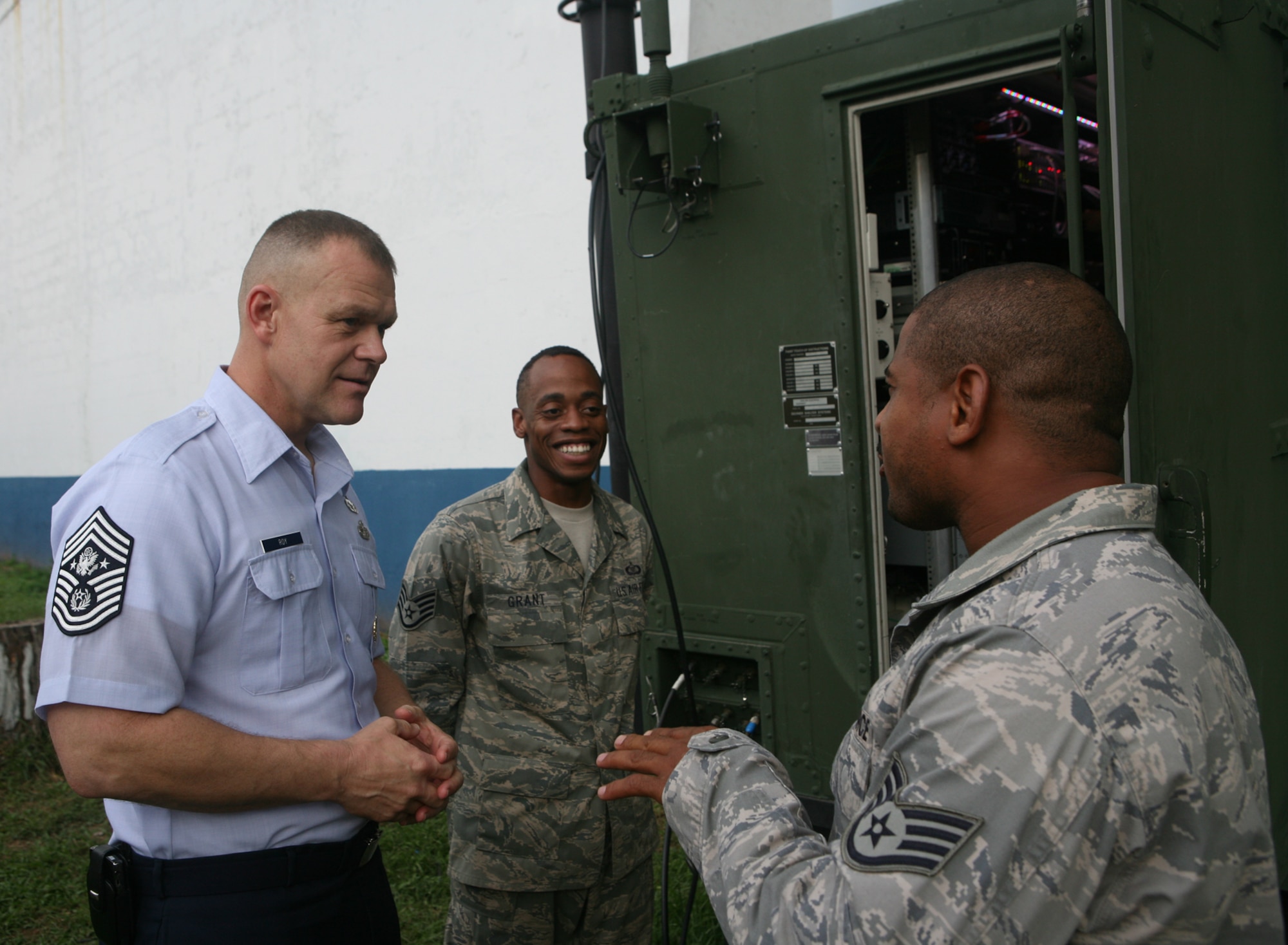 PANAMA CITY, Panama -- Chief Master Sgt. of the Air Force James A. Roy (left) speaks to Staff Sgt. Leighton Grant (center) and Staff Sgt. Rodney Hawkins during a visit with Airmen of the 612th Air Expeditionary Communications Squadron deployed at Capitán Juan Delgado Air Base during Fuerzas Aliadas PANAMAX 2009. FA PANAMAX 2009 is a multinational exercise with 20 participating countries tailored to the defense of the Panama Canal, involving over 4,500 personnel from the U. S. Southern Command area of focus. (U.S. Navy photo by Mass Communication Specialist 1st Class David P. Coleman)