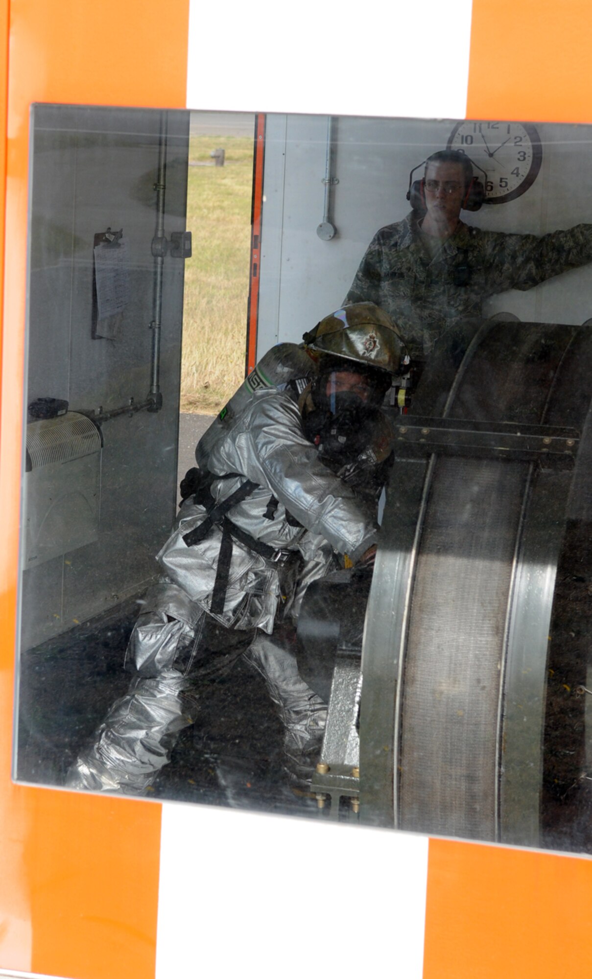 RAF MILDENHALL, England – A 100th Civil Engineer Squadron firefighter mans a massive hydraulic reel while resetting aircraft arresting gear here Sept. 22.  The gear was engaged by an F-15 from the 48th Fighter Wing, RAF Lakenheath, during an annual test of the arresting system.  (U.S. Air Force photo/Staff Sgt. Austin M. May)