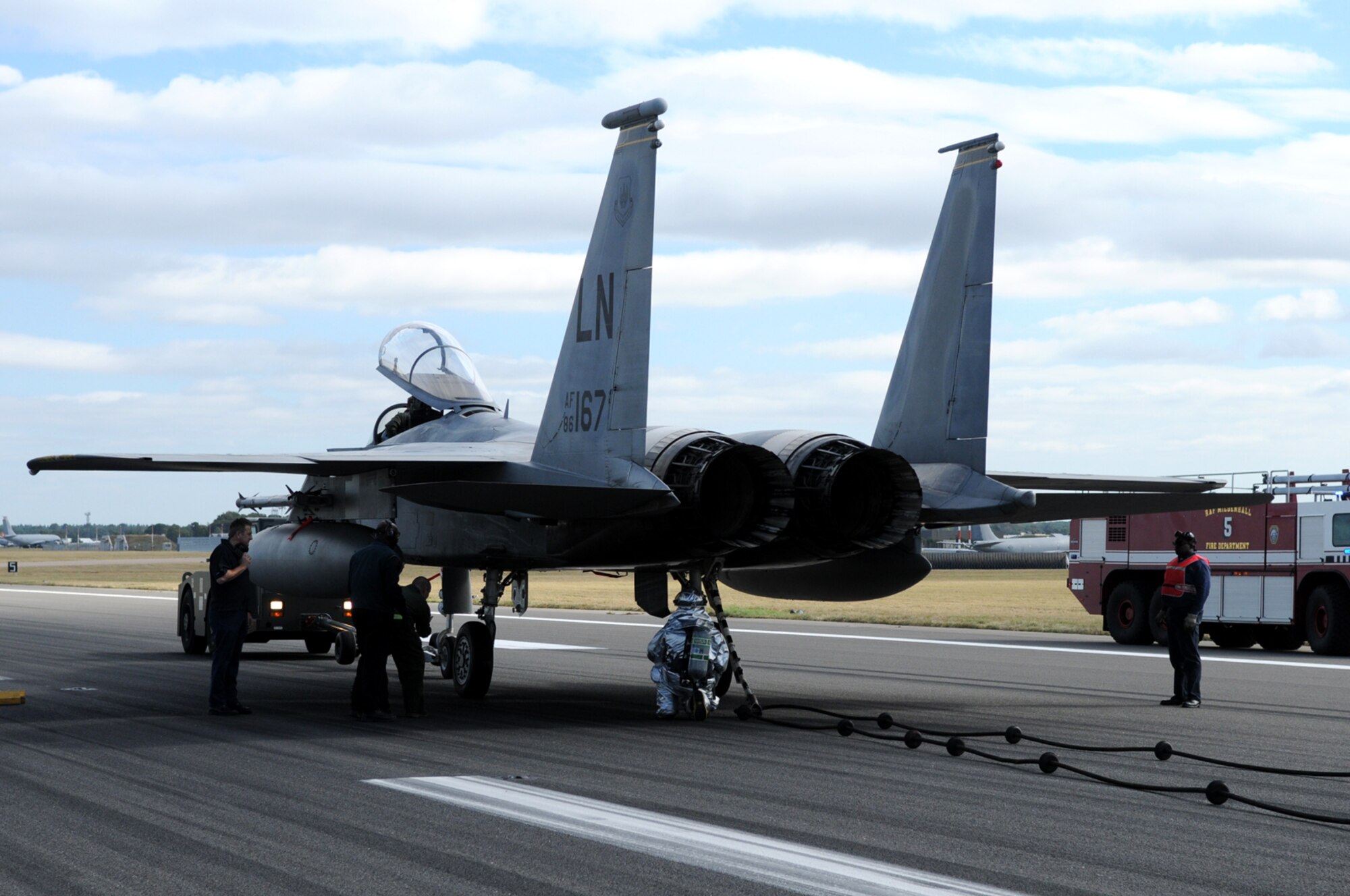 RAF MILDENHALL, England – Emergency crews tend to an F-15 from the 48th Fighter Wing, RAF Lakenheath, after it was stopped by arresting gear during an exercise Sept. 22.  The gear must be checked annually, so the fighter engaged it while taxiing at about 90 knots.  (U.S. Air Force photo/Staff Sgt. Austin M. May)