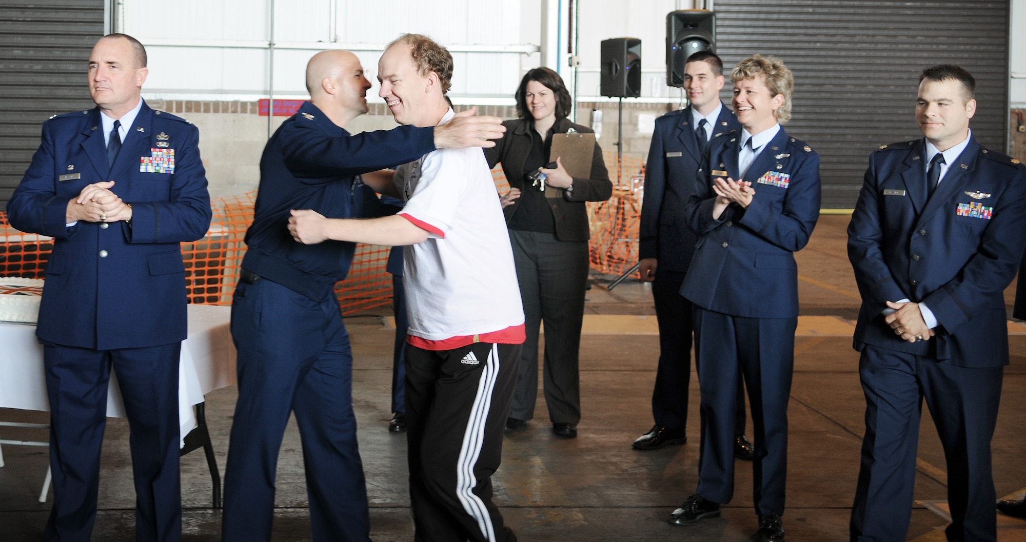 RAF MILDENHALL, England -- Stevie Welch, Joan Mann Special Sports Day participant (white shirt), left the line of the Parade of Athletes to greet Col. Chad Manske, 100th Air Refueling Wing commander, and the rest of the official party at Hangar 711 Sept. 19. Stevie and other special-needs athletes merged on RAF Mildenhall for a day of friendly competition. (U.S. Air Force photo/Senior Airman Thomas Trower)