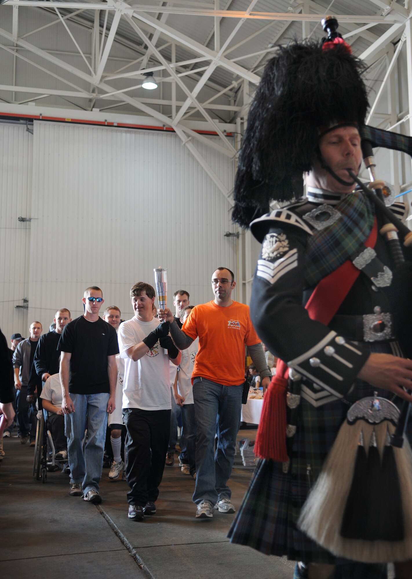RAF MILDENHALL, England -- Participants and volunteers for the 28th Annual Joan Mann Special Sports Day perform the Parade of Athletes at Hangar 711 Sept. 19. The event is geared to allow special-needs athletes an atmosphere for friendly competition. It was started by Joan Mann, a former Ministry of Defence employee working in the public affairs office here. (U.S. Air Force photo/Senior Airman Thomas Trower)