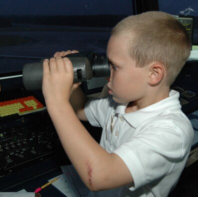Jeremy Payne, 8, peers through binonculars while touring the Dobbins air traffic control tower last September. Jeremy provided the inspiration behind the second place commentary titled "Different perspective changes attitude" in the 2009 Air Force Reserve Command Media Contest written by Senior Airman Shaun Shenk of the 94th Public Affairs office. The 94th PA staff also won best Web publication for www.dobbins.afrc.af.mil. 