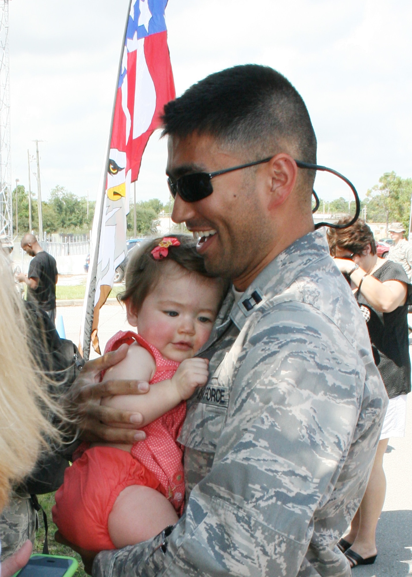 Captain Eric Bein, 728th Air Control Squadron air battle manager, receives a welcome home hug after returning from his first Operation Iraqi Freedom deployment with his unit Sept. 21. As one of the Air Combat Command’s four unique Control and Reporting Centers, more than 150 members of the 728th ACS provided command and control of joint air operations using surveillance, identification, weapons control, battle management and theater data links while overseas. (U.S. Air Force photo/2nd Lt. Andrew Caulk)