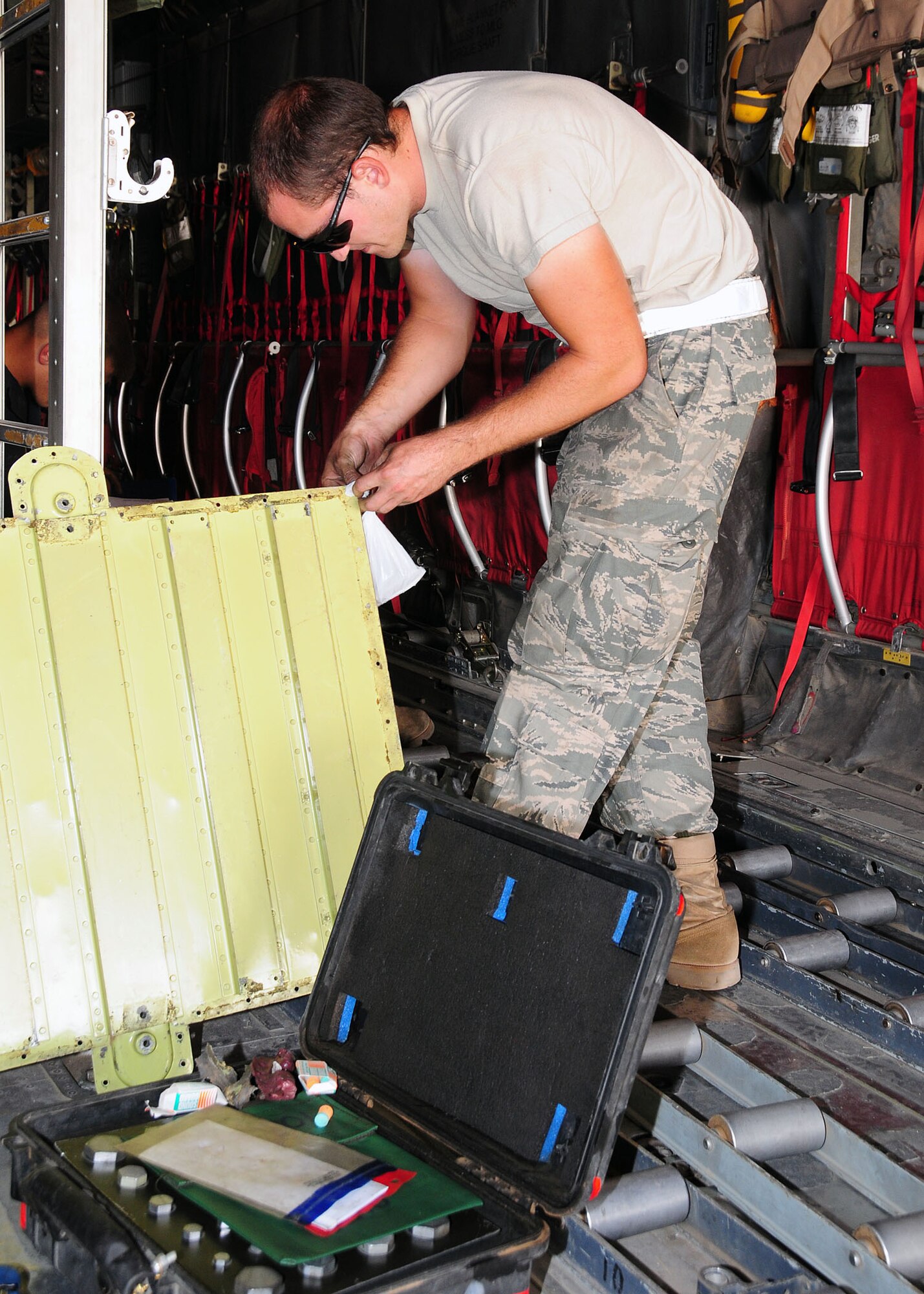 SOUTHWEST ASIA -- Airman 1st Class Bryant Nielsen, 386th Expeditionary Aircraft Maintenance Squadron crew chief, attaches hardware to a C-130 Hercules floor panel at an undisclosed location in Southwest Asia Sept. 21, 2009.  Airman Nielsen is deployed from the 317th Airlift Group, Dyess Air Force Base, Texas and hails from Antioch, Calif.  (U.S. Air Force photo/Tech. Sgt. Tony Tolley) 