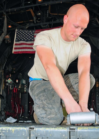 Airman 1st Class Joshua Larson, 386th Expeditionary Aircraft Maintenance Squadron aircraft hydraulics, removes C-130 Hercules cargo rollers from a plane at an undisclosed location in Southwest Asia on Sept. 21, 2009. Airman Larson is deployed from the 317th Airlift Group, Dyess Air Force Base, Texas, and hails from Kennewick, Wash. (U.S. Air Force Photo/Tech. Sgt. Tony Tolley) 