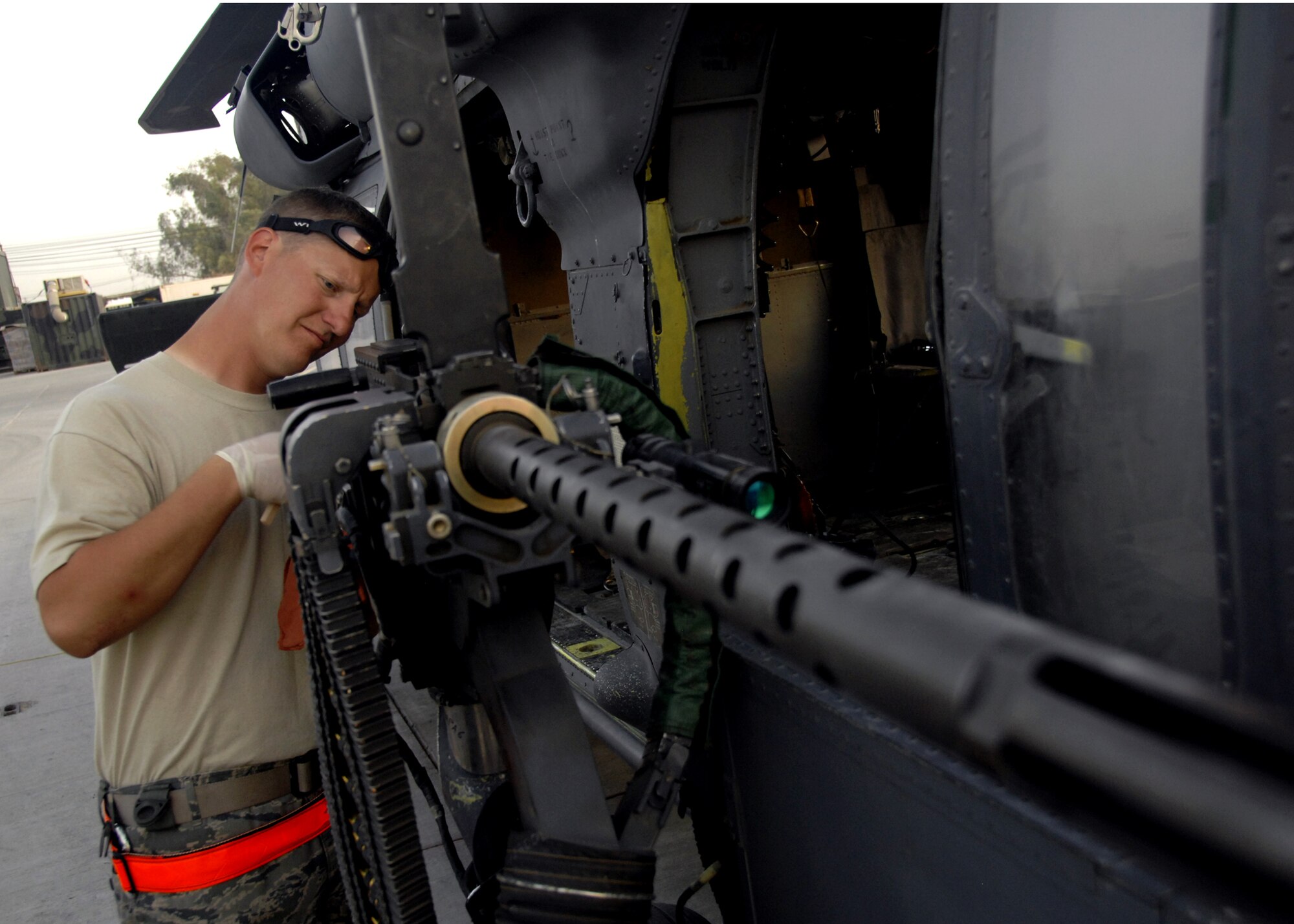 Master Sgt. Marty Skipper cleans and inspects a GAU-18 .50-caliber machine gun during a pre-flight inspection of an HH-60 Pave Hawk here, Sept. 21, 2009. Sergeant Skipper is an armament systems technician with the 55th Expeditionary Helicopter Maintenance Unit deployed from Davis-Monthan Air Force Base, Ariz. and hails from Loris, S.C. (U.S. Air Force photo/Senior Airman Timothy Taylor)