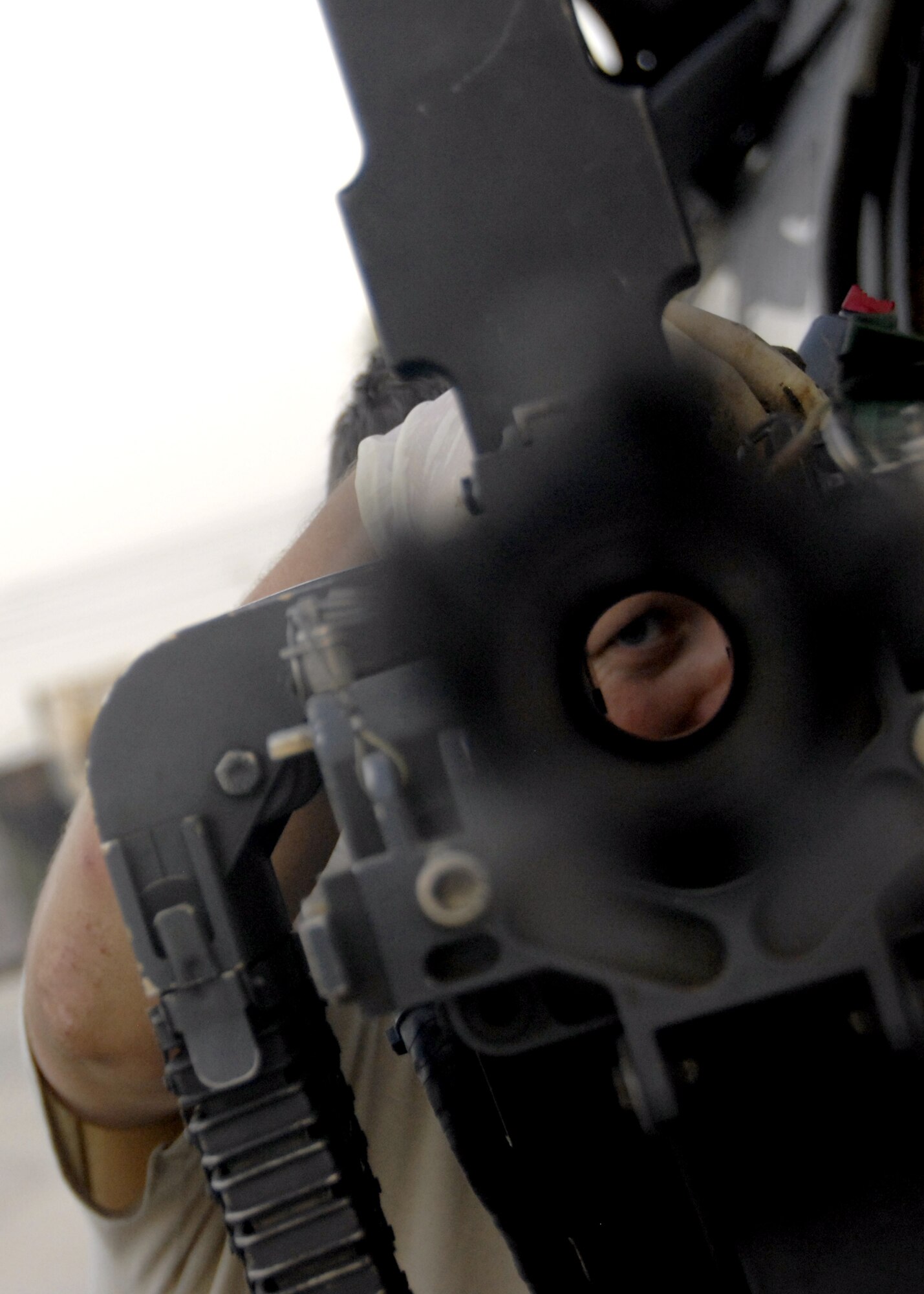 Master Sgt. Marty Skipper peers down the barrel of a GAU18 .50-caliber machine gun checking for burrs, loose rounds or stoppadges during a pre-flight inspection of an HH-60 Pave Hawk here, Sept. 21, 2009. Sergeant Skipper is an armament systems technician with the 55th Expeditionary Helicopter Maintenance Unit from Davis-Monthan Air Force Base, Ariz. and hails from Loris, S.C. (U.S. Air Force photo/Senior Airman Timothy Taylor)