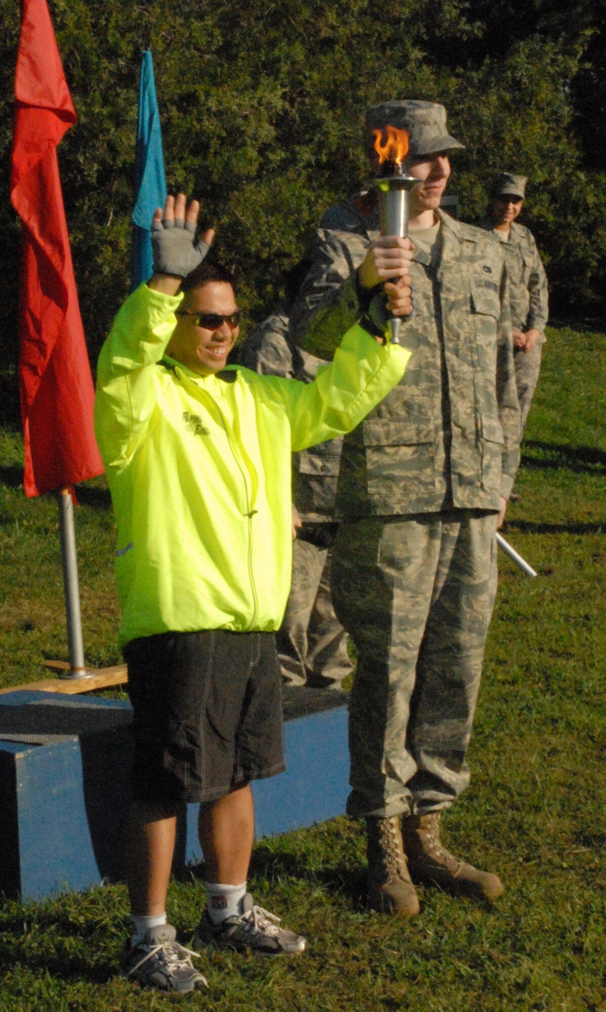 Airman 1st Class Matthew Filcher, 436th Aerial Port Squadron, hands off the olympic torch to a Special Olympics competitor to start the games Sept. 19.  (U.S. Air Force photo/Staff Sgt. Chad Padgett) 