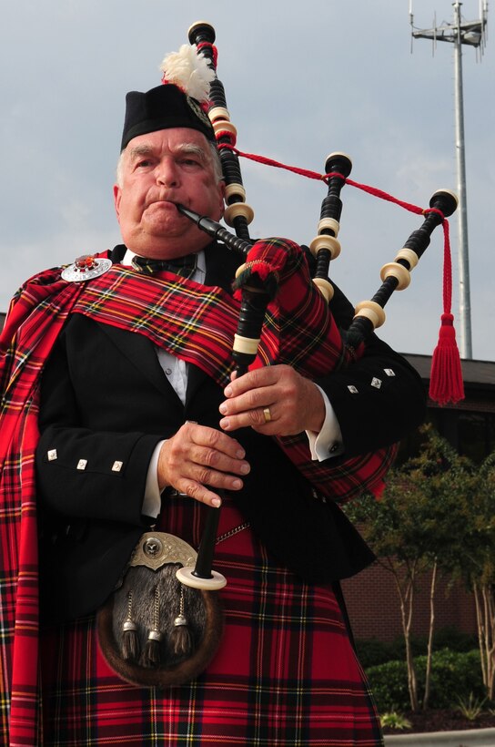 Retired Lt. Col. Norm Taflinger, performs Amazing Grace on the bagpipes during the folding of the American flag in a Prisoner of War - Missing in Action remembrance ceremony at Seymour Johnson Air Force Base, N.C., Sept. 18, 2009. The bagpipe adaptation of Amazing Grace did not become a part of U.S. military ceremonies until the 1960s. It is often associated with funerals and a remembrance of those killed in war. (U.S. Air Force photo by Airman 1st Class Rae Perry)