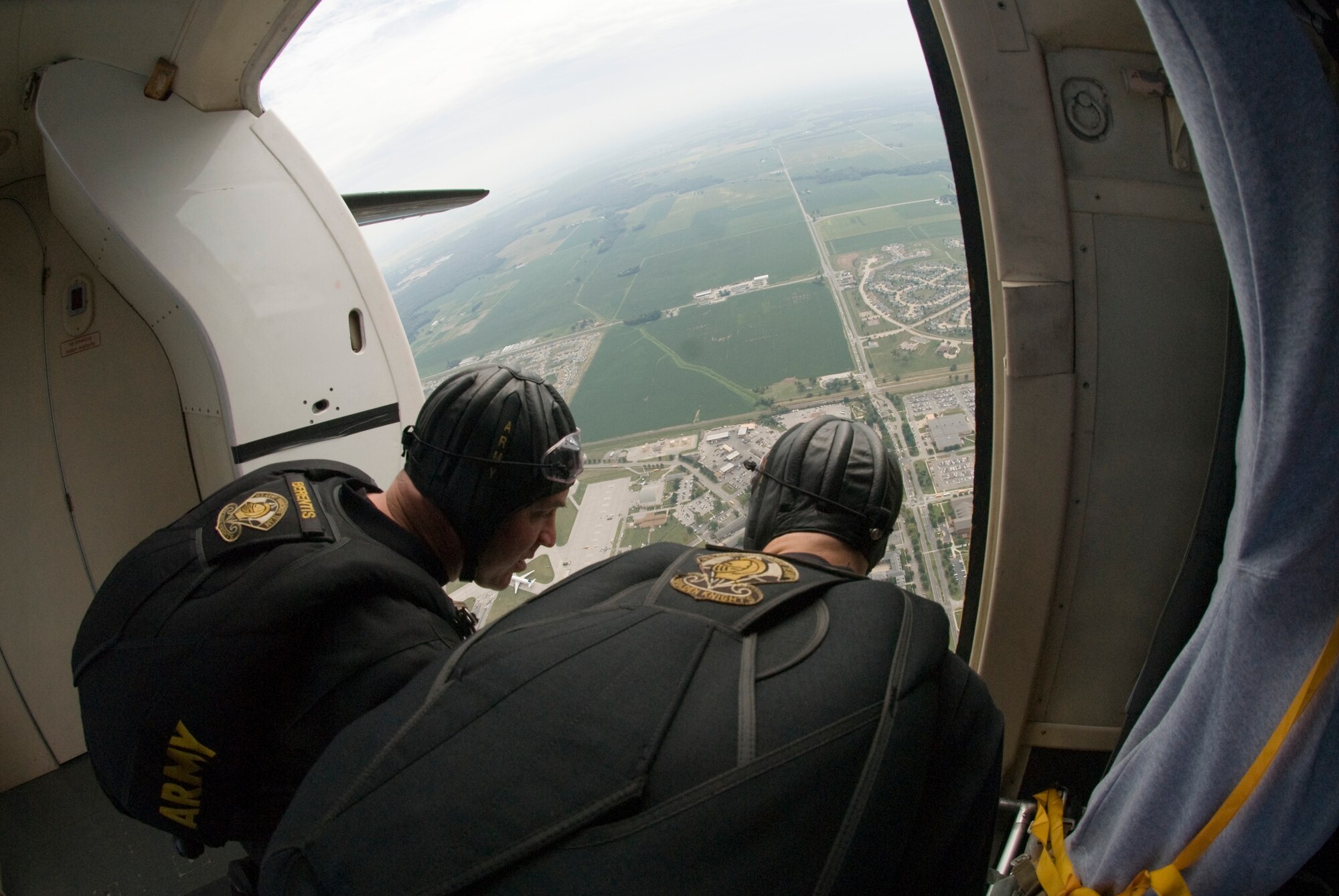 SCOTT AIR FORCE BASE, Ill. -- Sergeant First Class John Berentis and Sergeant Reese Pendelton look over the edge of the Golden Knights Fokker C-31 aircraft to make sure they are over the hot zone. (U.S. Air Force photo/ Senior Airman Andrew Davis)