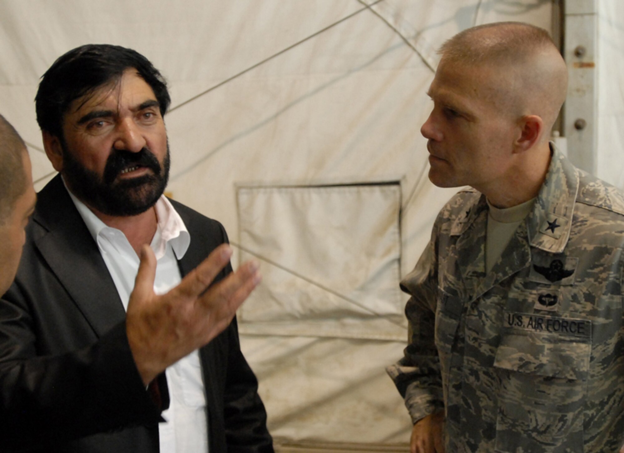 BAGRAM AIRFIELD, Afghanistan -- Abdal Rahman Mangal, Deputy Governor of Paktya province, Afghanistan, speaks with Brig Gen. Steven Kwast, commander, 455th Air Expeditionary Wing, during the Eid ul-Fitr celebration at Bagram Airfield, Afghanistan, Sept. 21. Many dignitaries, coalition leaders and professionals met to celebrate the Muslim holiday ending the fasting of Ramadan. (U.S. Army photo/Spc. William E. Henry) 