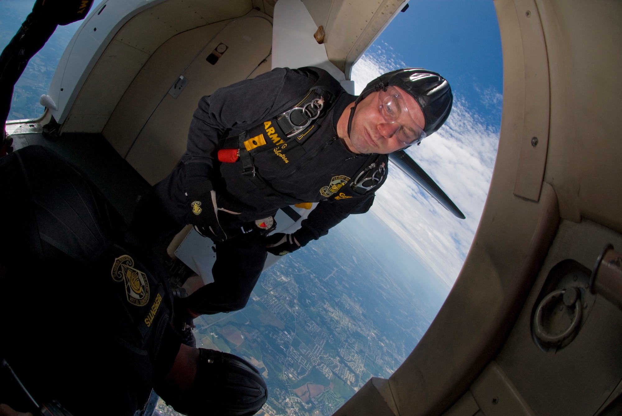 SCOTT AIR FORCE BASE -- Staff Sgt. Steven Robertson prepares to jump from the Golden Knights Fokker C-31 aircraft as Sergeant First Class John Berentis watches to make sure he clears the tail of the aircraft.The Sergeants are form the Army's Golden Knight Parachute Gold Team who performed this weekend at the Scott AFB 2009 Airpower over the Midwest Air Show. (U.S. Air Force photo/ Senior Airman Andrew Davis)