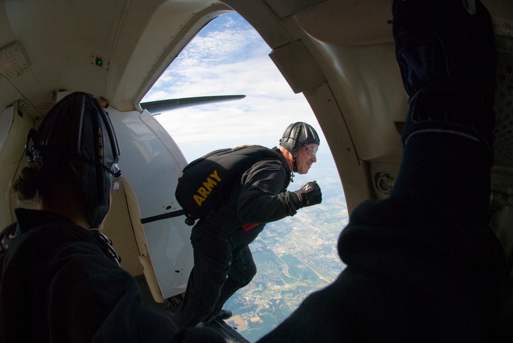 SCOTT AIR FORCE BASE -- Sergeant First Class John Berentis takes a leap before free falling 11,000 feet during the Golden Knights performance at the air show. After exiting the aircraft Sergeant First Class Berentis meet up mid-air with three other members to form a diamond formation flying inches apart from each other.   (U.S. Air Force photo/ Senior Airman Andrew Davis)