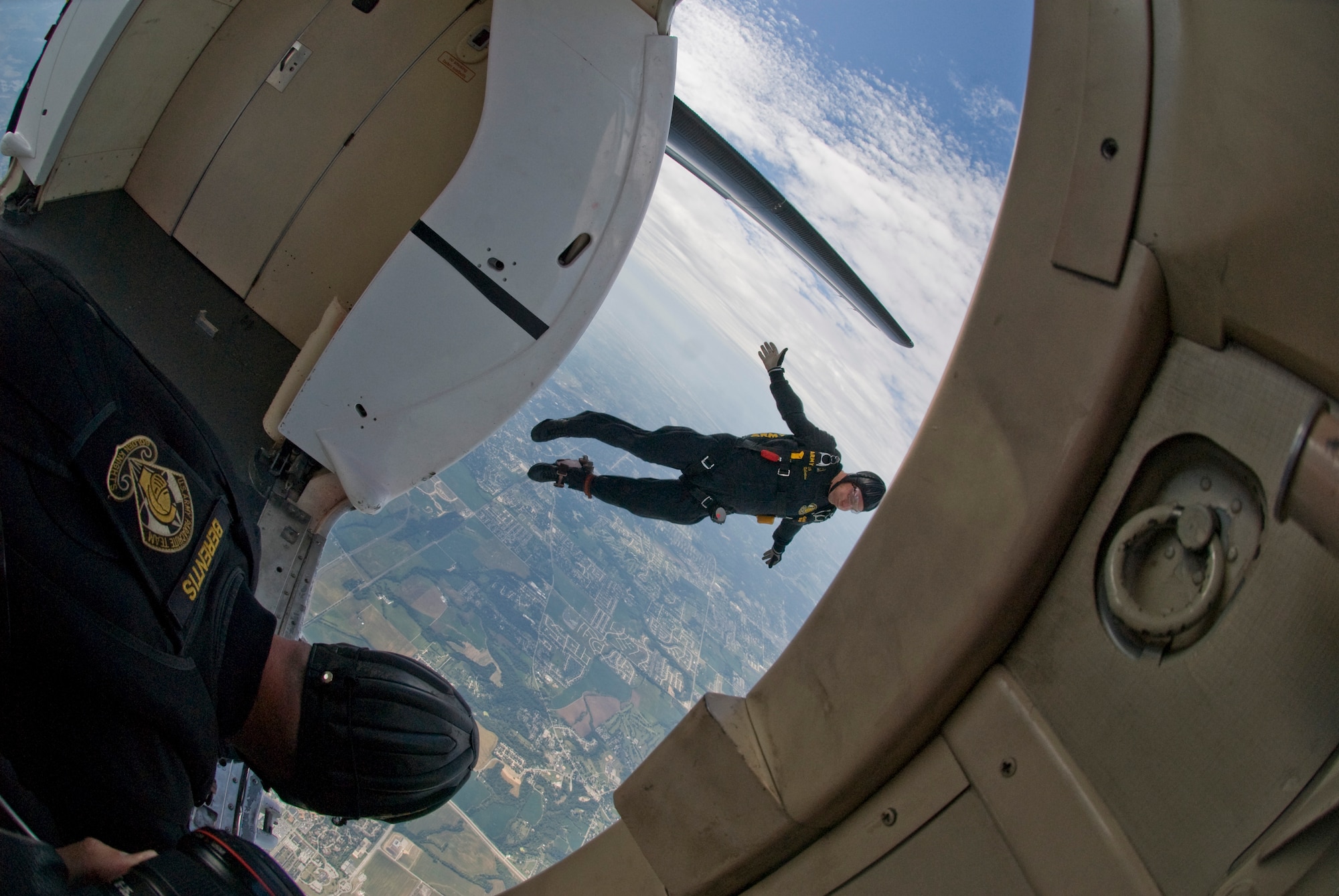 SCOTT AIR FORCE BASE, Ill. -- Golden Knight Gold Team member Army Staff Sgt. Steven Robertson jumps from the Golden Knights Fokker C-31 aircraft as Sergeant First Class John Berentis watches to make sure he clears the tail of the aircraft. The two sergeants are part of the Army’s Golden Knights Parachute Team who performed this weekend. (U.S. Air Force photo/ Senior Airman Andrew Davis) 
