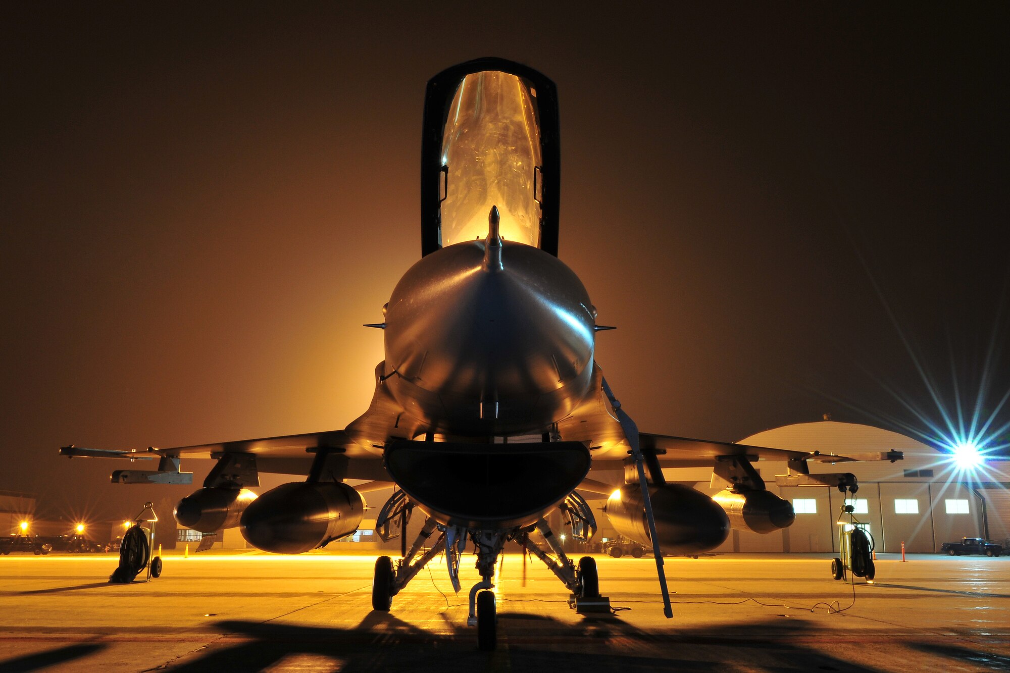 An F-16 fighter jet stands ready for departure at Truax Field in Madison, Wis. early on the morning of  September 22, 2009. The 115th Fighter Wing launched 14 F-16s early Tuesday morning as part of the wings scheduled Aerospace Expeditionary Force rotation that began last week when approximately 200 of the unit's members deployed in support of Operation Iraqi Freedom. (US Air Force photo by Master Sgt. Paul Gorman)