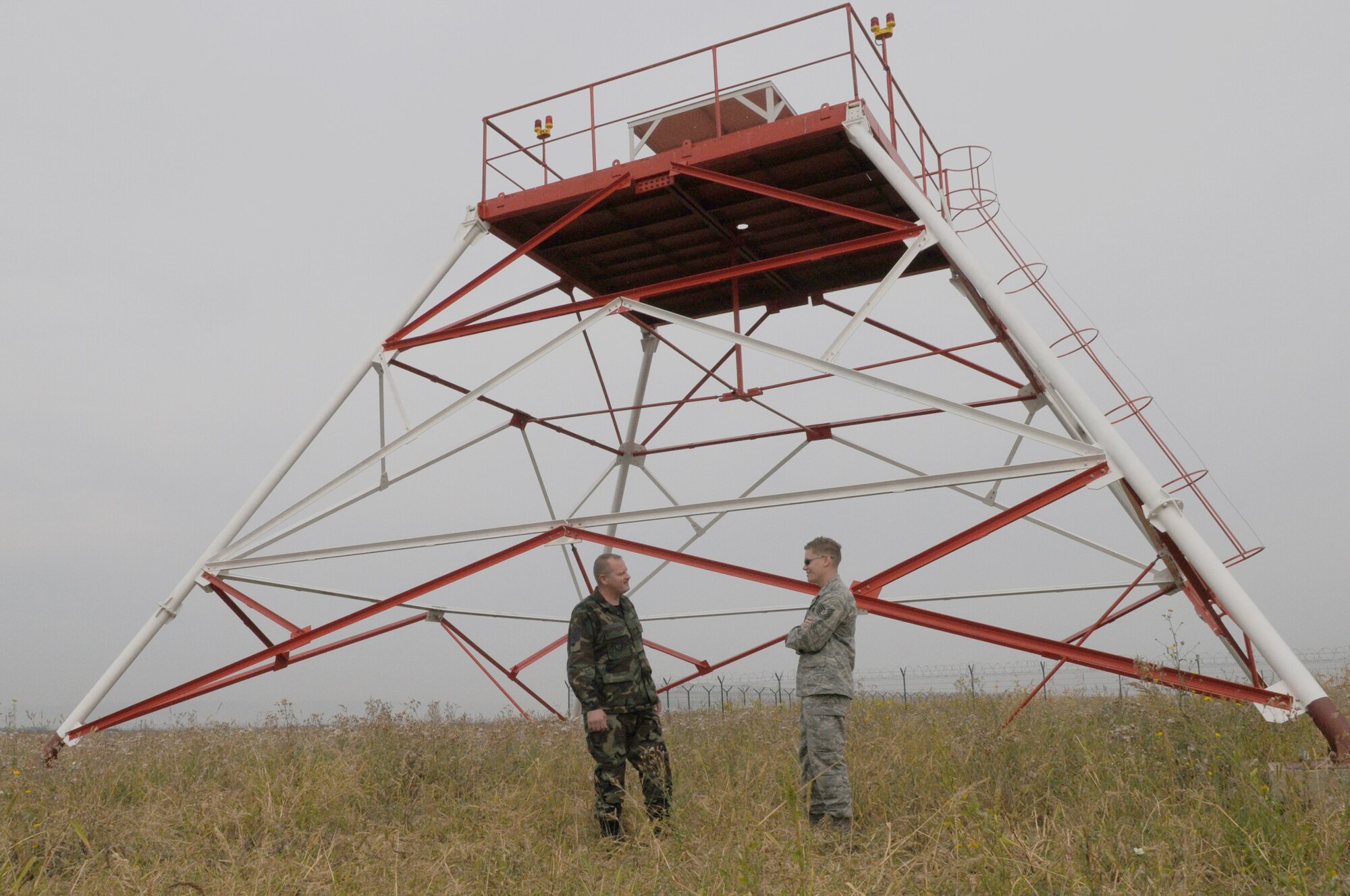U.S. Air Force Master Sgt. Jerry McDonald and Tech. Sgt. Aaron Tibbits, both 1st Communications Maintenance Squadron special communications team members, discuss what is needed for the installation of the Tactical Air Navigation System during the final site inspection, Camp Turzii, Romania, Sept. 17, 2009. The installation of the TACAN will provide better communication capabilities between the air and ground forces in the area, and it will also help strengthen the bonds between the United States and the host nation. (U.S. Air Force photo by Airman 1st Class Alexandria Mosness)