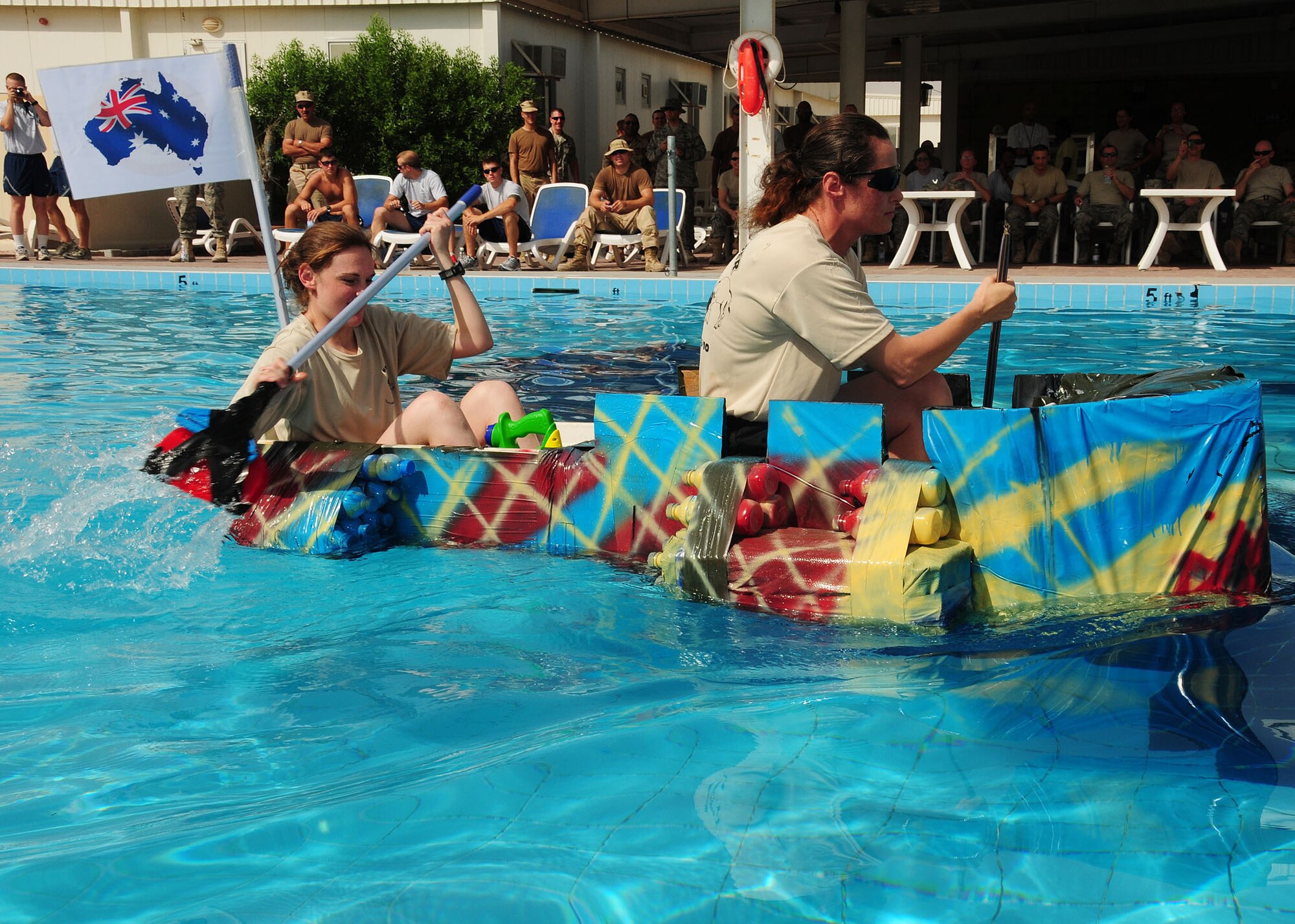 SOUTHWEST ASIA -- Australian Defence Force Support Unit Two members paddle during the Coalition Games build-a-boat completion held at the 386th Air Expeditionary Wing pool at an undisclosed location in Southwest Asia Sept. 19, 2009.  (U.S. Air Force photo/Tech. Sgt. Tony Tolley)