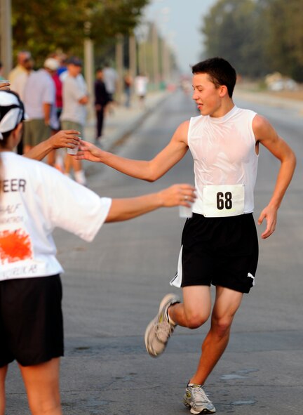 Luke Gray, 15-year-old son of Col. Lawrence Gray, 39th Air Base Wing vice commander, grabs a cup of water at the Incirlik Half Marathon Saturday, Sept. 19, 2009.  Grey came in third place for men under 35 with a time of 1 hour, 39 minutes and 54 seconds.  More than 80 runners participated in the event.  (U.S. Air Force photo/Staff Sgt. Raymond Hoy) 