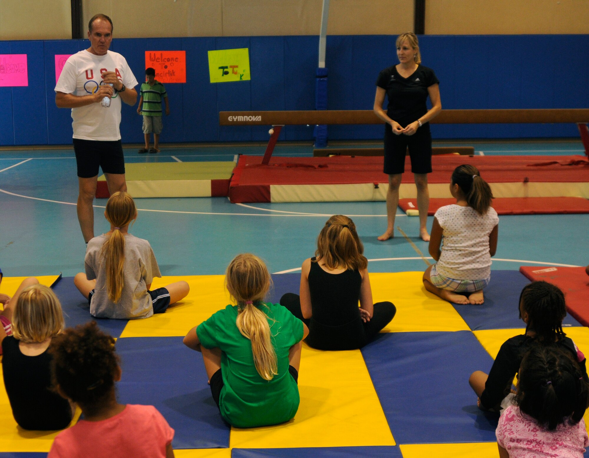 Craig Virgin, an American Olympian, introduces Karen Fox, his agent and 14 year gymnastics judge with U.S. Gymnastics, to youth center children Wednesday, Sept. 16, 2009, during a gymnastics class that Ms. Fox taught at Incirlik Air Base, Turkey. Mr. Virgin, along with Ms. Fox came to Incirlik for morale support and to help start off Incirlik’s half-marathon. (U.S. Air Force photo by/Airman 1st Class Amber Ashcraft)