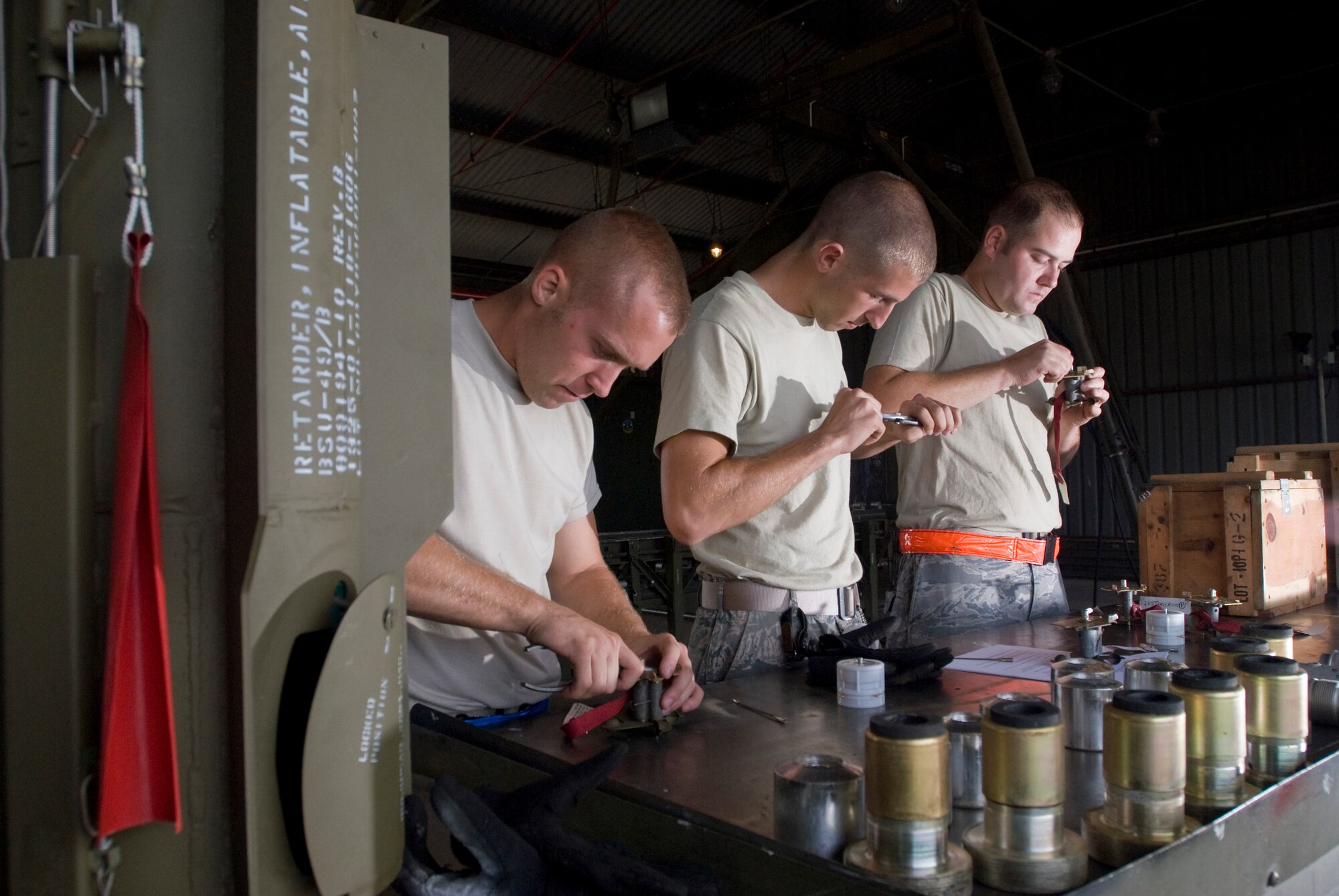 KUNSAN AIR BASE, Republic of Korea -- Airman 1st Class Robert Locke, Airman 1st Class Christopher Lewis and Senior Airman Michael Burdge, 8th Maintenance Squadron, disassembles various parts from a MK-82, a 500 pound free fall, general- purpose bomb, Sept. 22. The MK-82 is being disassembled to preserve service life of the components for future use. (U.S. Air Force photo / Senior Airman Jonathan Steffen)