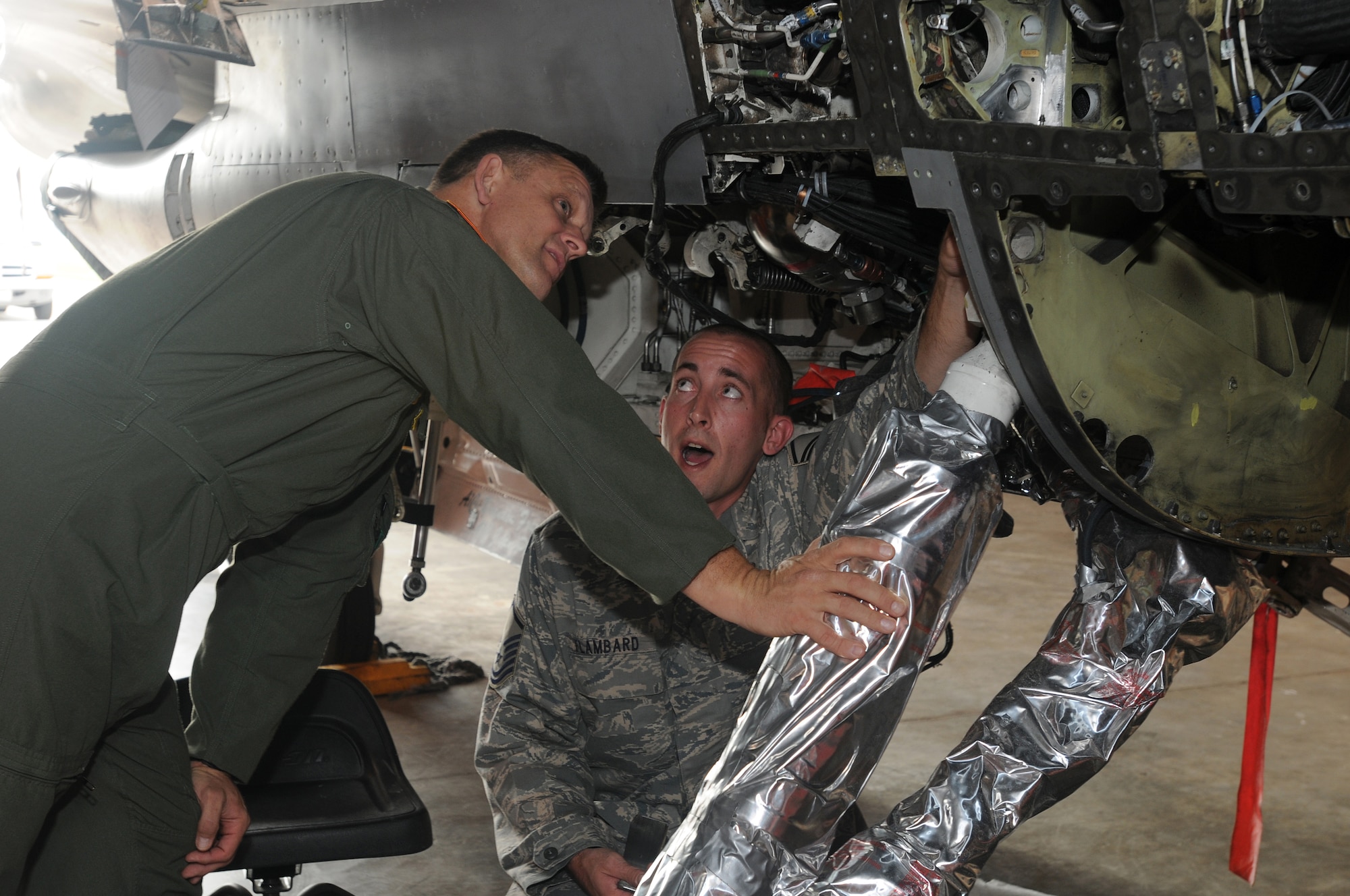 Master Sgt. Jeffrey Flambard, 31st Maintenance Squadron assistant fabrications flight chief, shows and describes repair procedures on the 341 bulkhead of an F-16 Fighting Falcon to Lt. Gen. Frank Gorenc, 3rd Air Force commander, Sept. 18, 2009 in Hangar 1 on the flight line Aviano Air Base, Italy.  The 341 bulkhead controls whether the F-16 will fly or not.  This was the commander's first visit to Aviano AB.  (U.S. Air Force photo/Airman 1st Class Ashley Wood)
