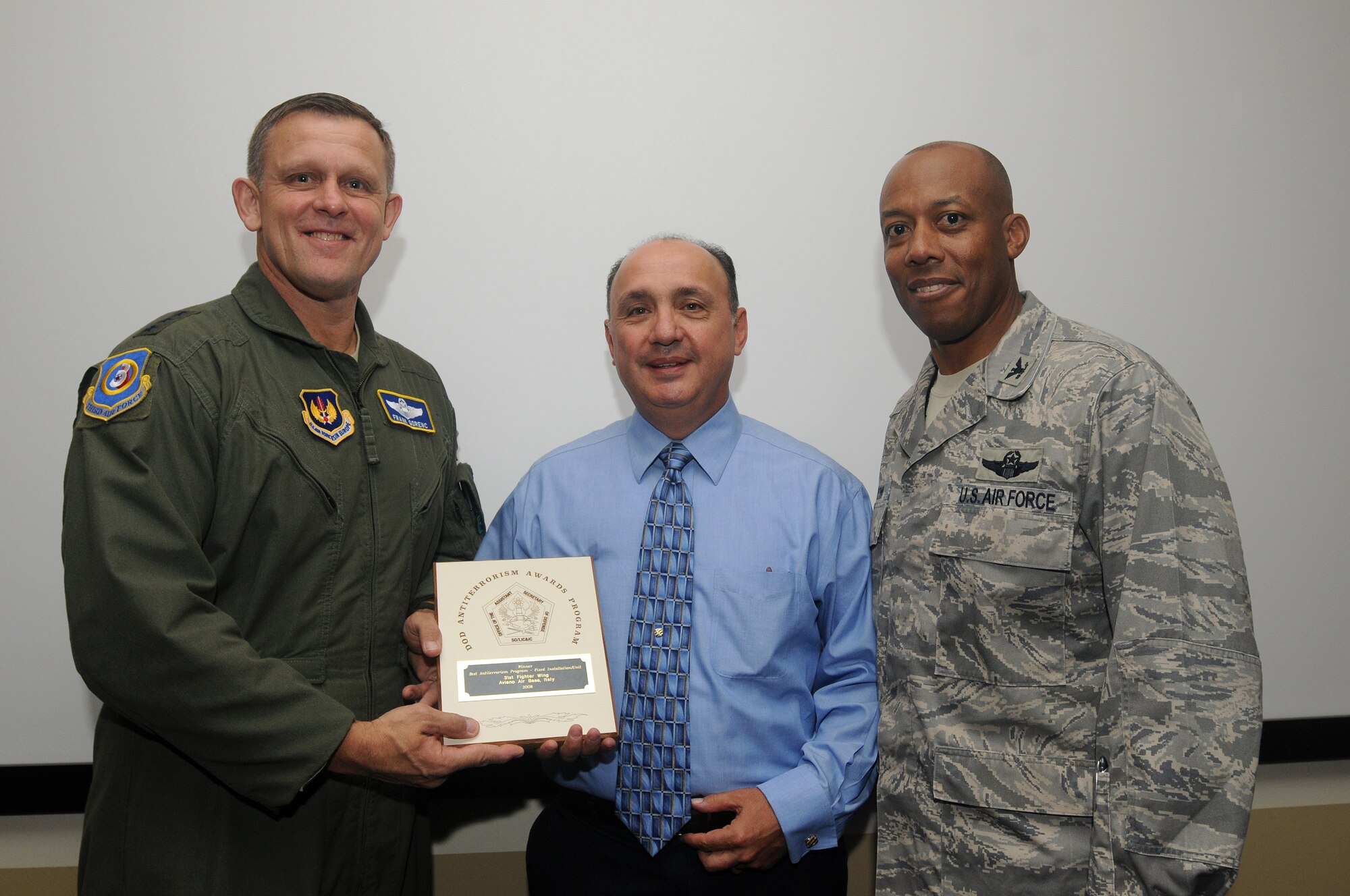 Bill Trevino (center), 31st Fighter Wing anti-terrorism officer, accepts the Department of Defense's 2008 Best AT Installation Award from Lt. Gen. Frank Gorenc, 3rd Air Force commander, and Col. Charles Q. Brown, Jr, 31st FW commander, Sept. 18, 2009 during the commander's first visit to Aviano Air Base, Italy.  (U.S. Air Force photo/Airman 1st Class Ashley Wood)